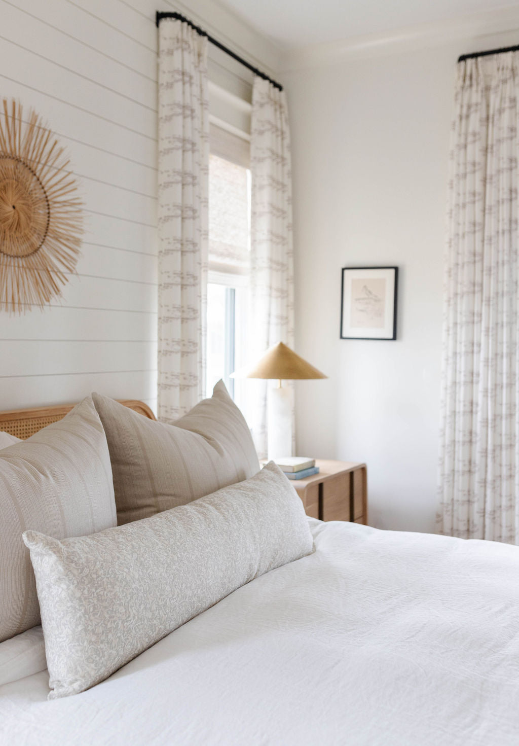 Sandbar pillow in Teak styled by Emily Daws – placed on a cane chair in a Charleston sunroom