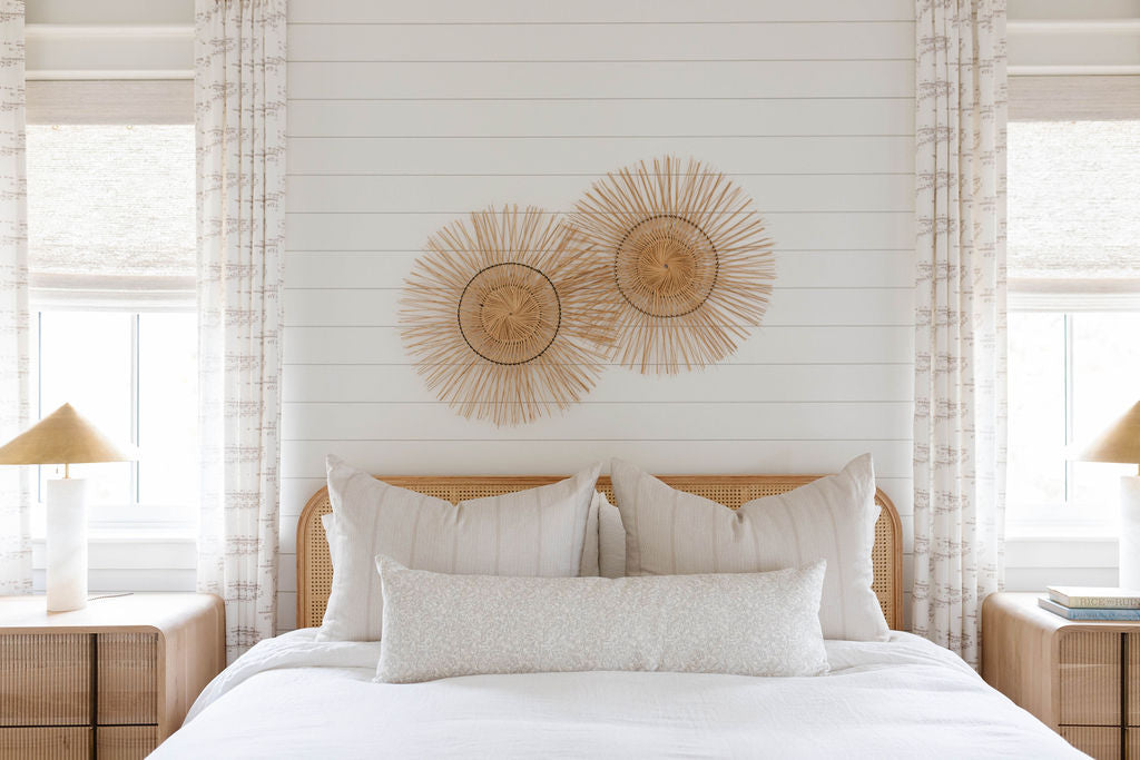 Sandbar pillow in Teak styled by Emily Daws – shown on a porch bench with other woven accents