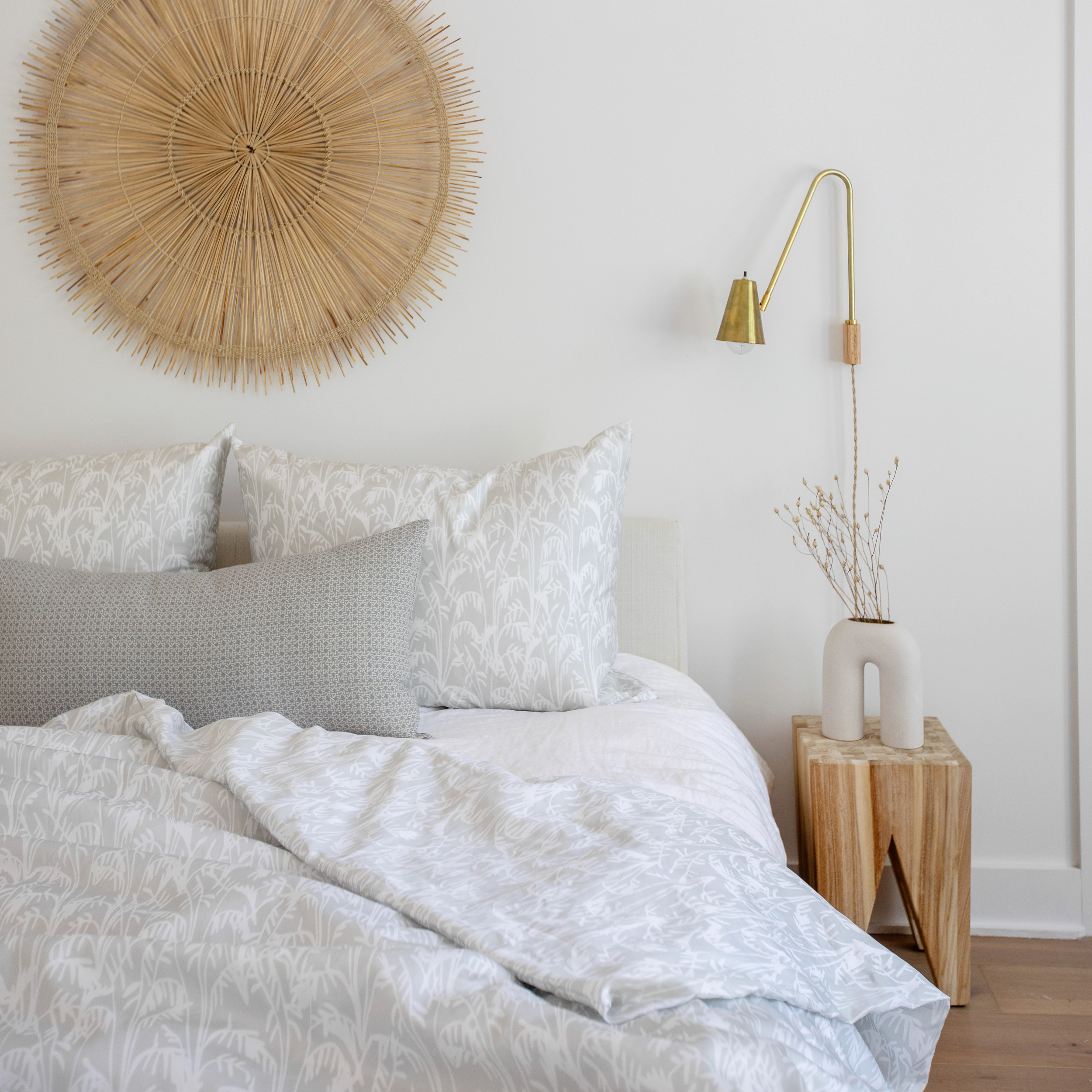 Emily Daws pillows displayed in a Charleston-inspired interior, styled with luxury textiles for artful living spaces.