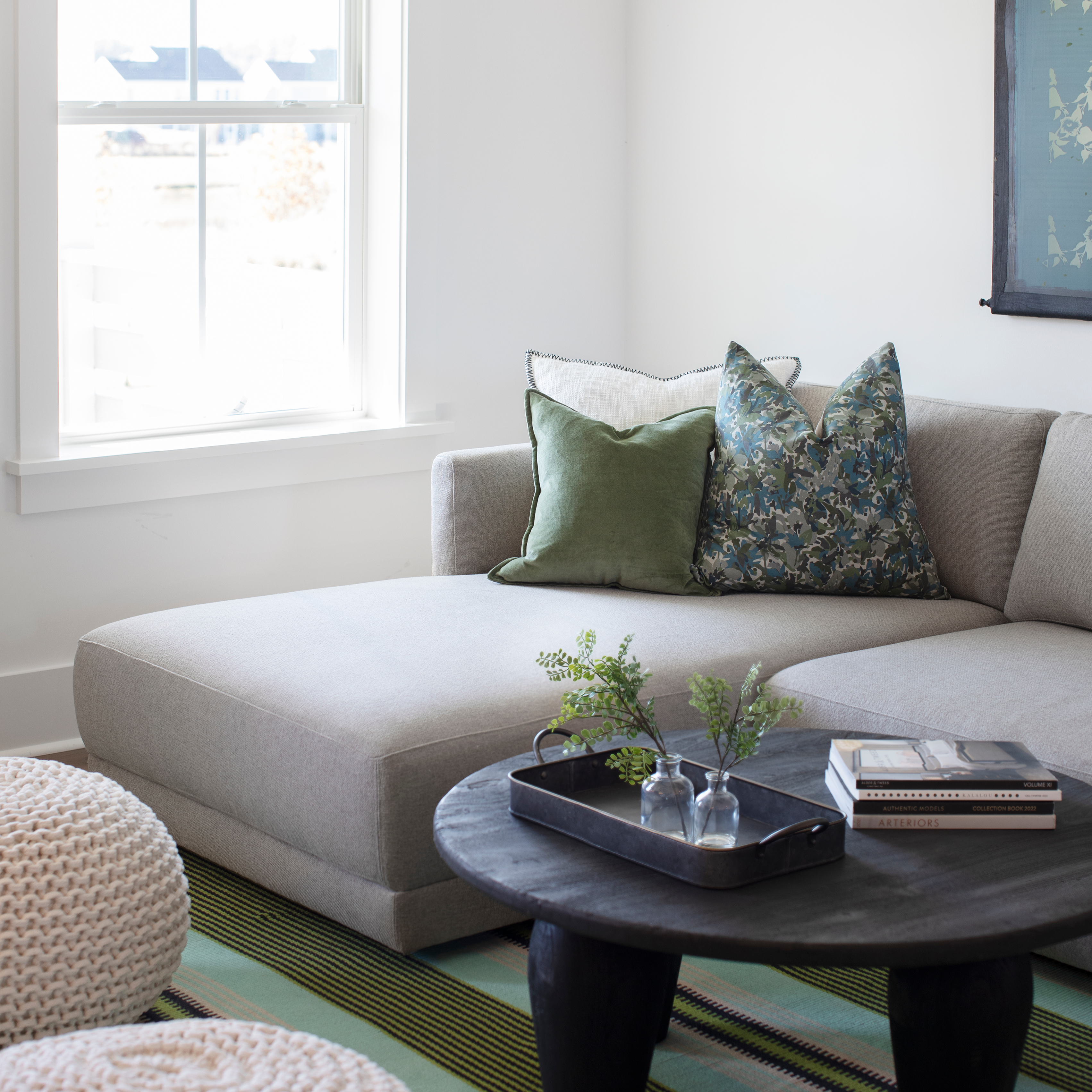 Thicket pillow in Emerald styled by Emily Daws – layered with quilts in a woodland bedroom setting