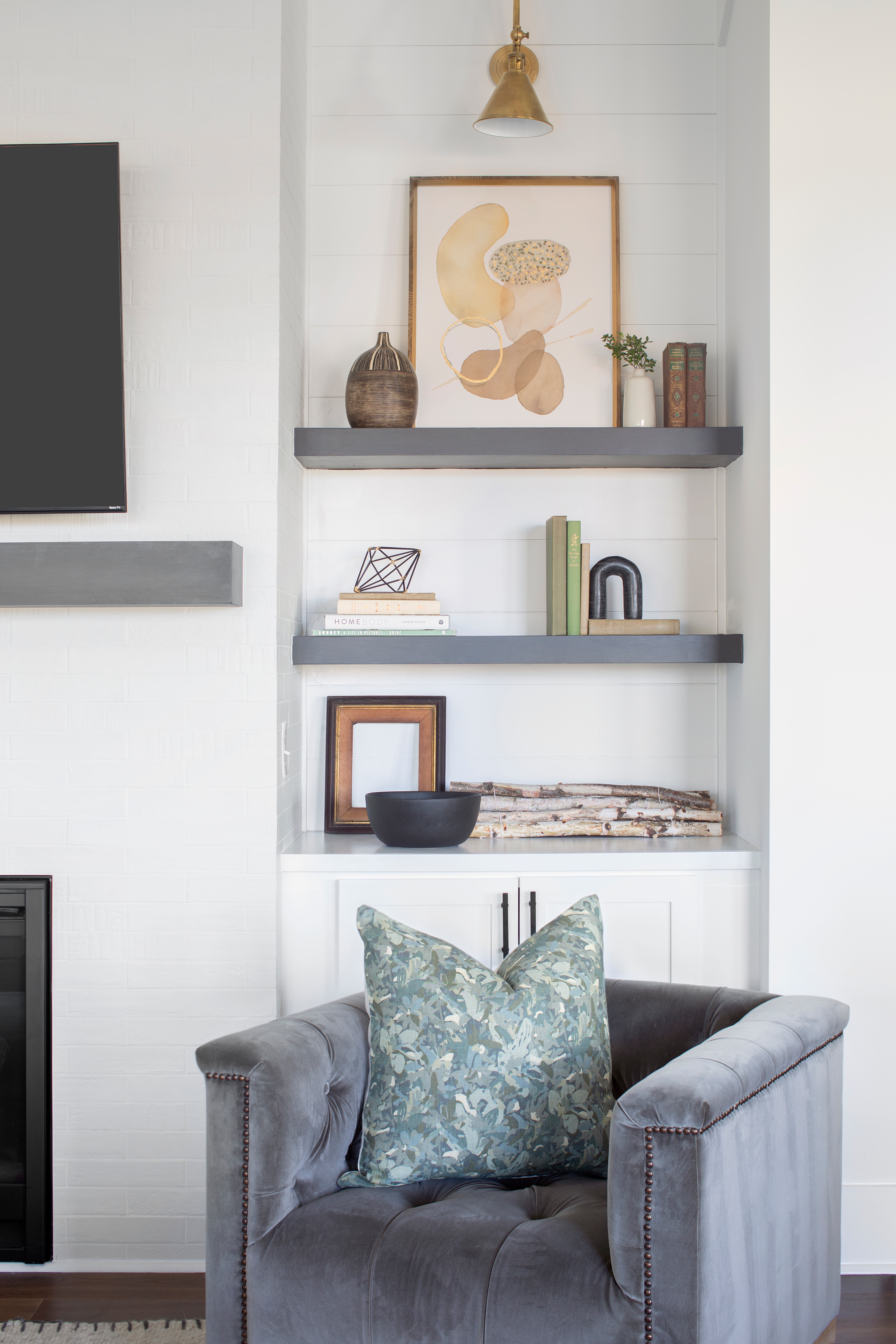 Thicket pillow in Shale styled by Emily Daws – layered with quilts in a woodland bedroom setting