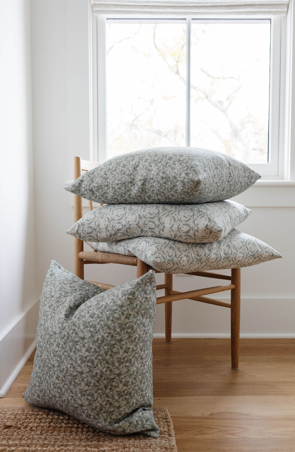 Tortoise pillow in Fig styled by Emily Daws – shown on a rustic bench with handmade quilts