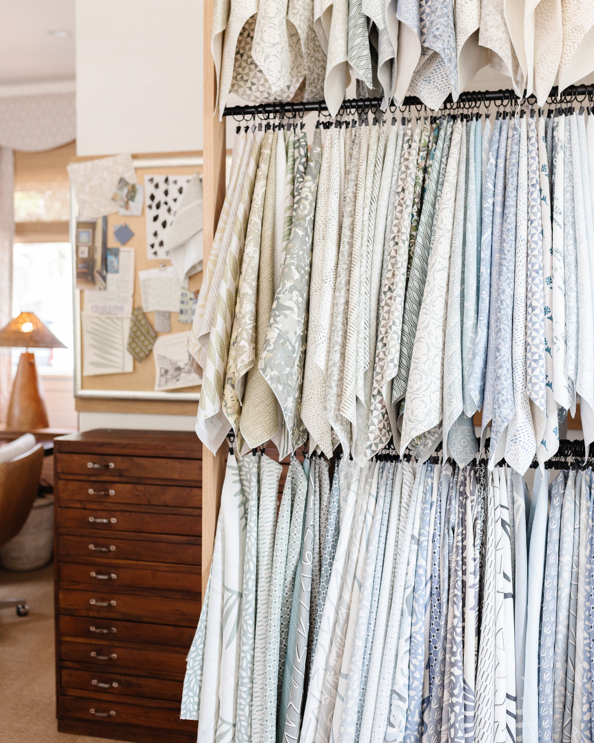 Display of printed linen fabrics hanging in the Charleston showroom for Emily Daws.
