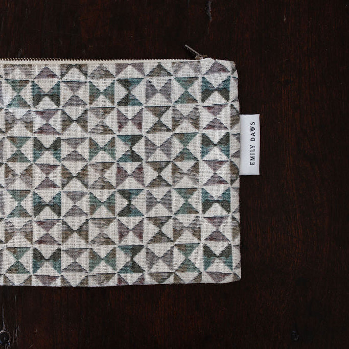 Fabric pouch with geometric pattern on a wooden surface