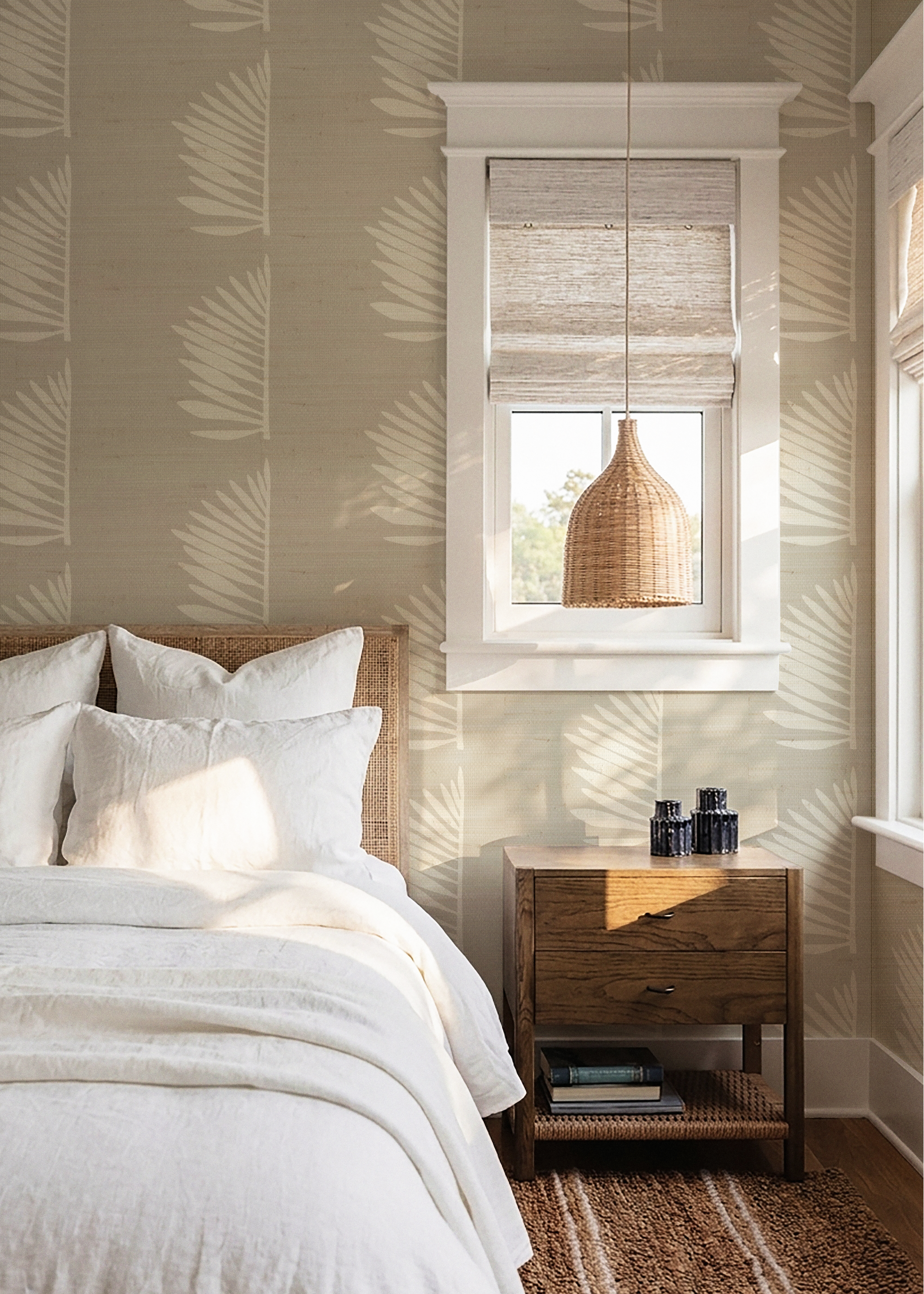 Bedroom with leaf-patterned wallpaper, wooden nightstand, and pendant light.