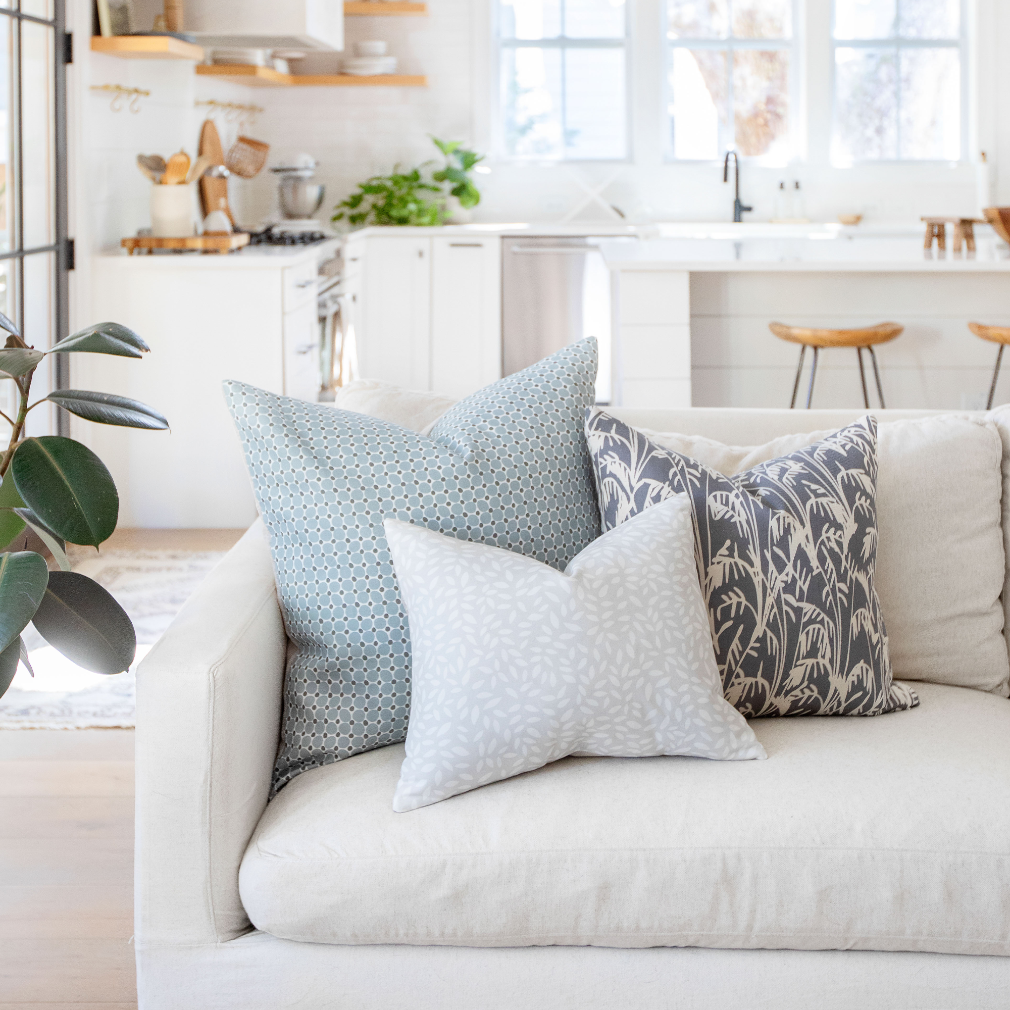 Cobblestone pillow in Lagoon styled by Emily Daws – placed on a vintage settee in a Charleston cottage