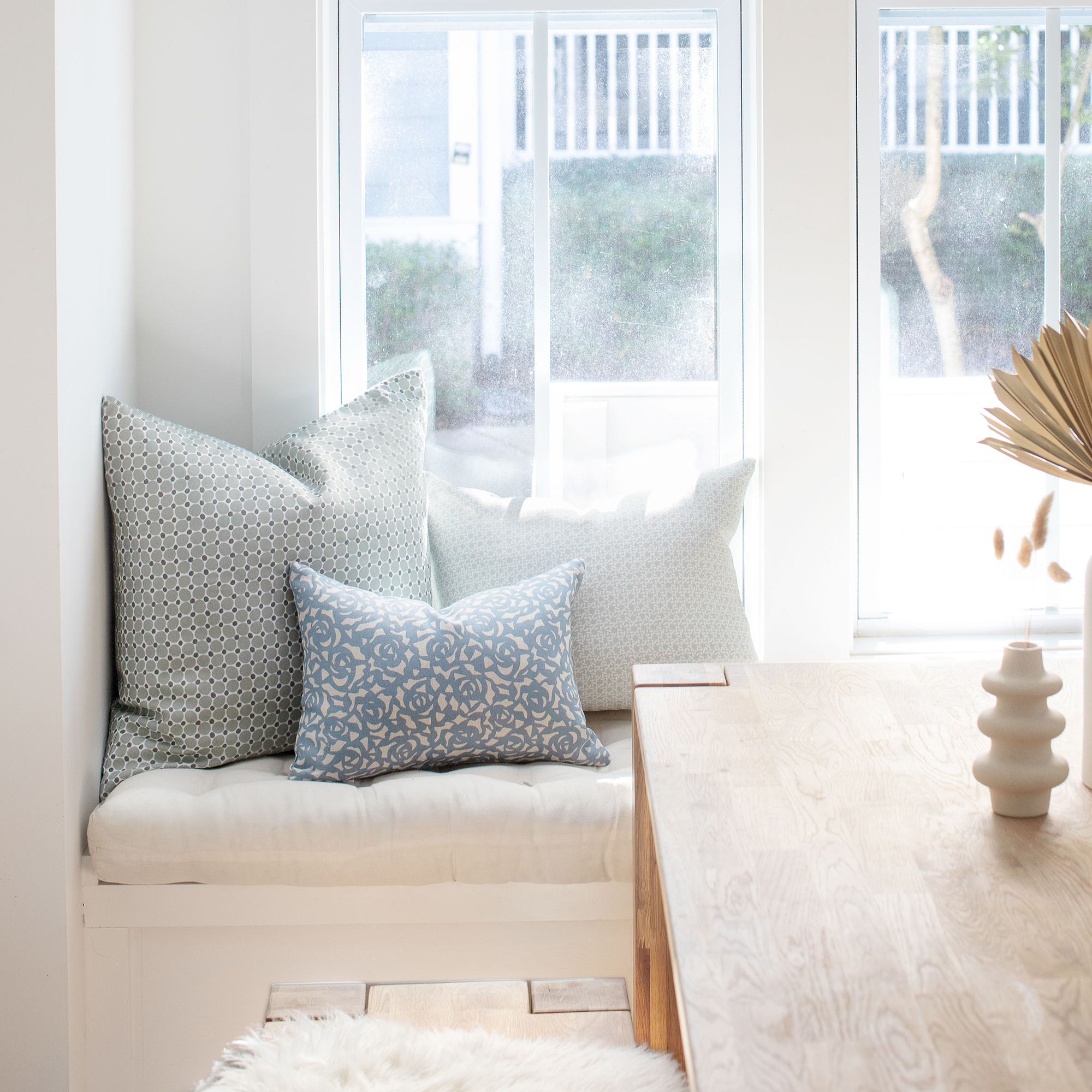 Cobblestone pillow in Olive styled by Emily Daws – placed on a vintage settee in a Charleston cottage