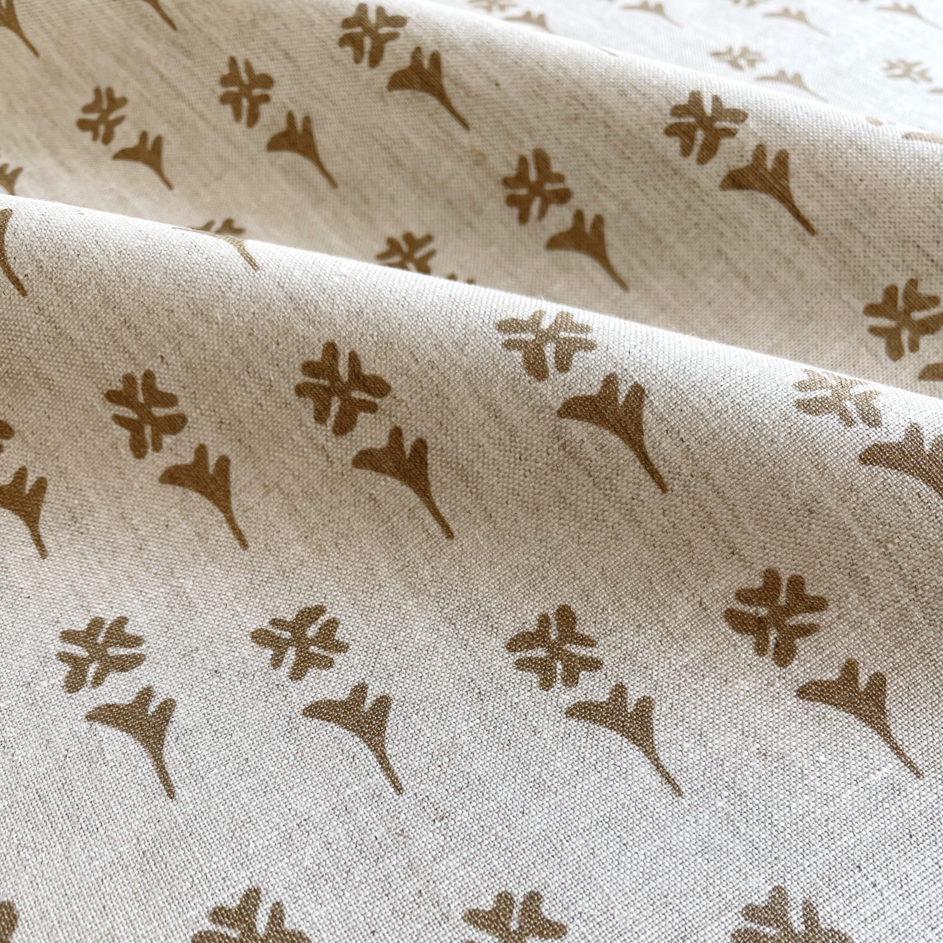 Daffodil fabric in Copper β close-up of linen texture and leafy pattern; perfect for pattern sofas