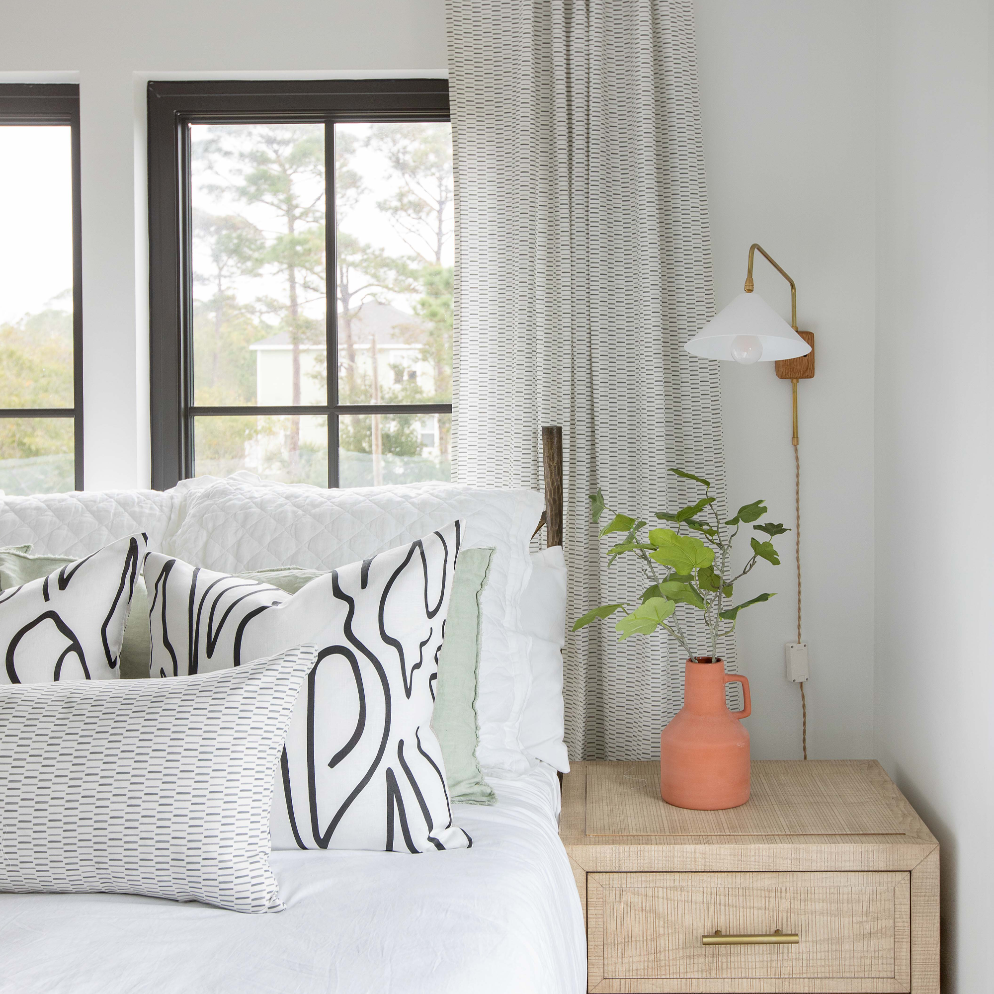 Emily Daws pillows layered on a bed, showcasing luxury textiles for interiors and timeless design.