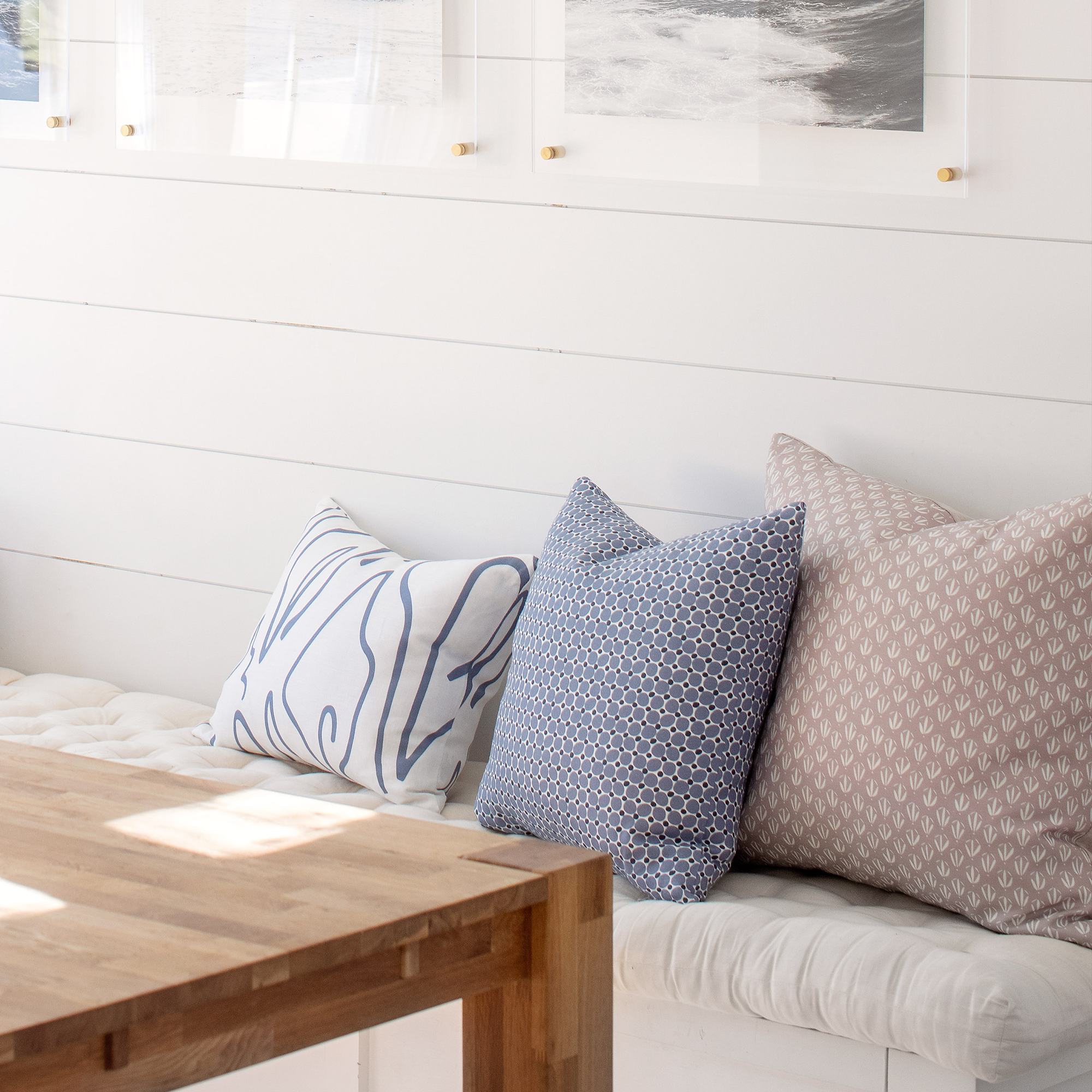 Bench seating styled with Emily Daws pillows in Belgian linen fabrics, created for trade professionals and clients.