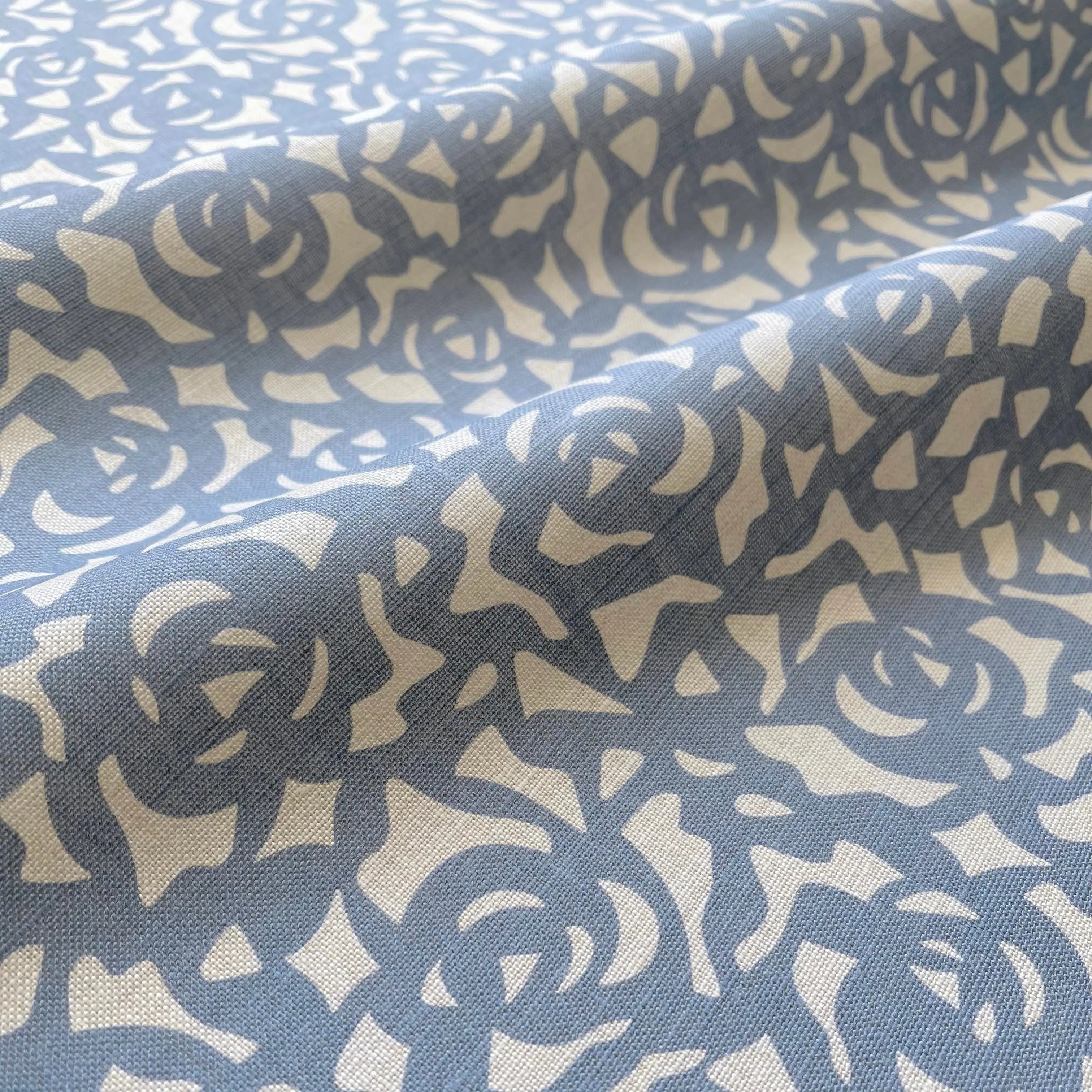 Gardenia Cobalt pillow by Emily Daws styled in an interior — Charleston Collection