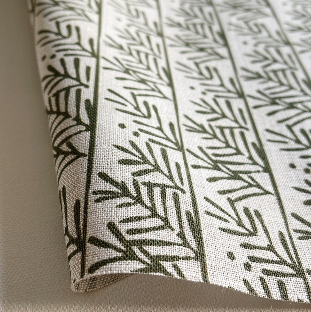 Hemlock pillow in Holly – fabric detail showing botanical print and linen texture from Flora Collection