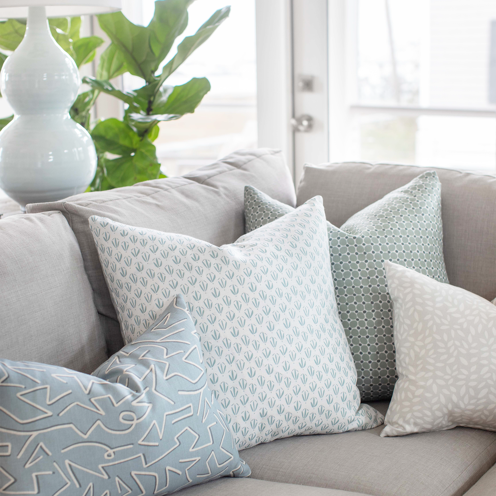 Decorative pillow arrangement by Emily Daws, styled for bespoke interiors and artful living spaces.