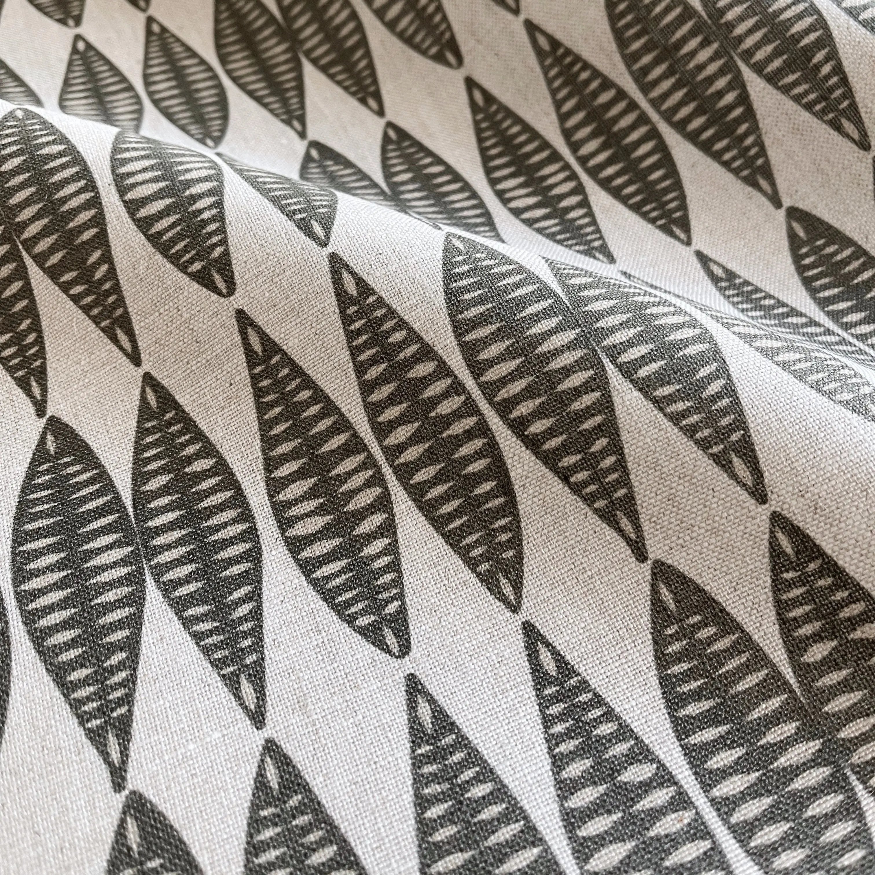 Leaflette Peppercorn pillow by Emily Daws styled in an interior — Flora Collection