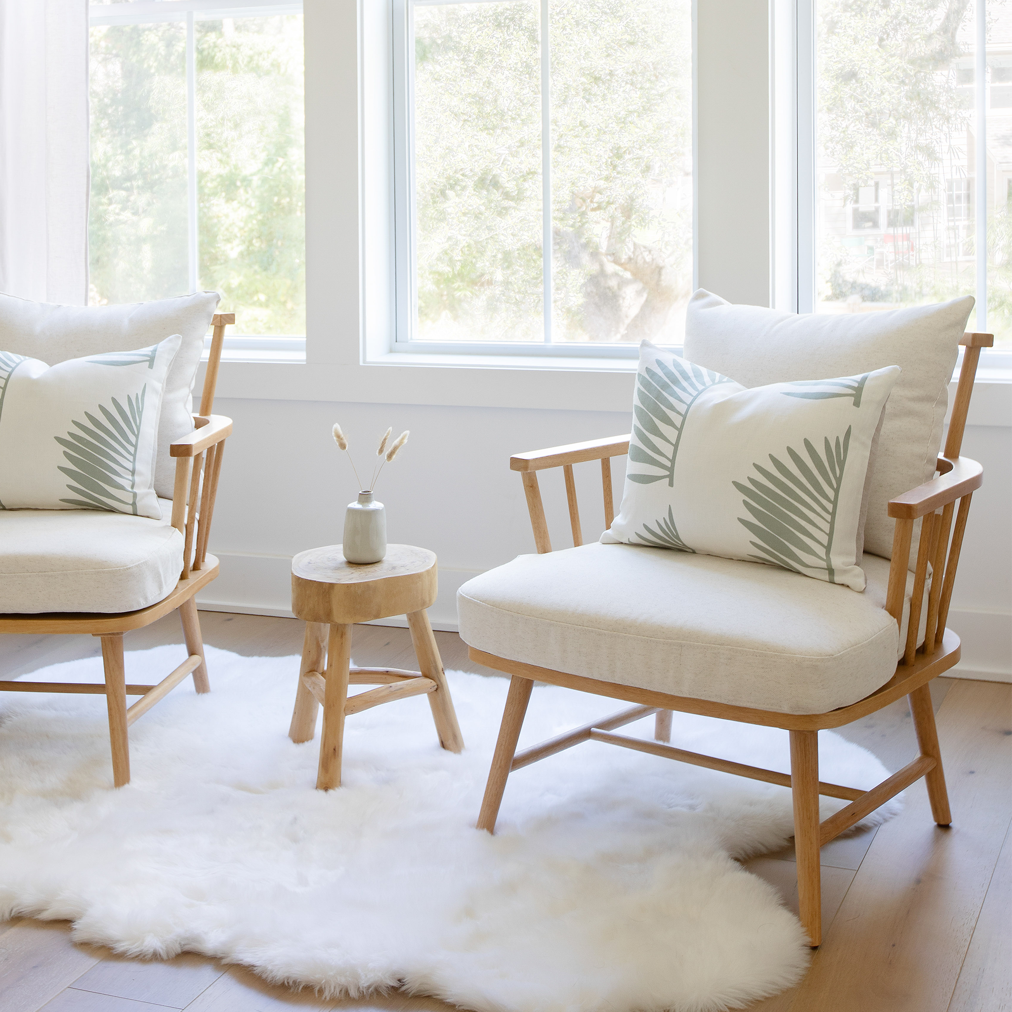 Palmetto pillow in Leaf styled by Emily Daws – placed on a vintage settee in a Charleston cottage