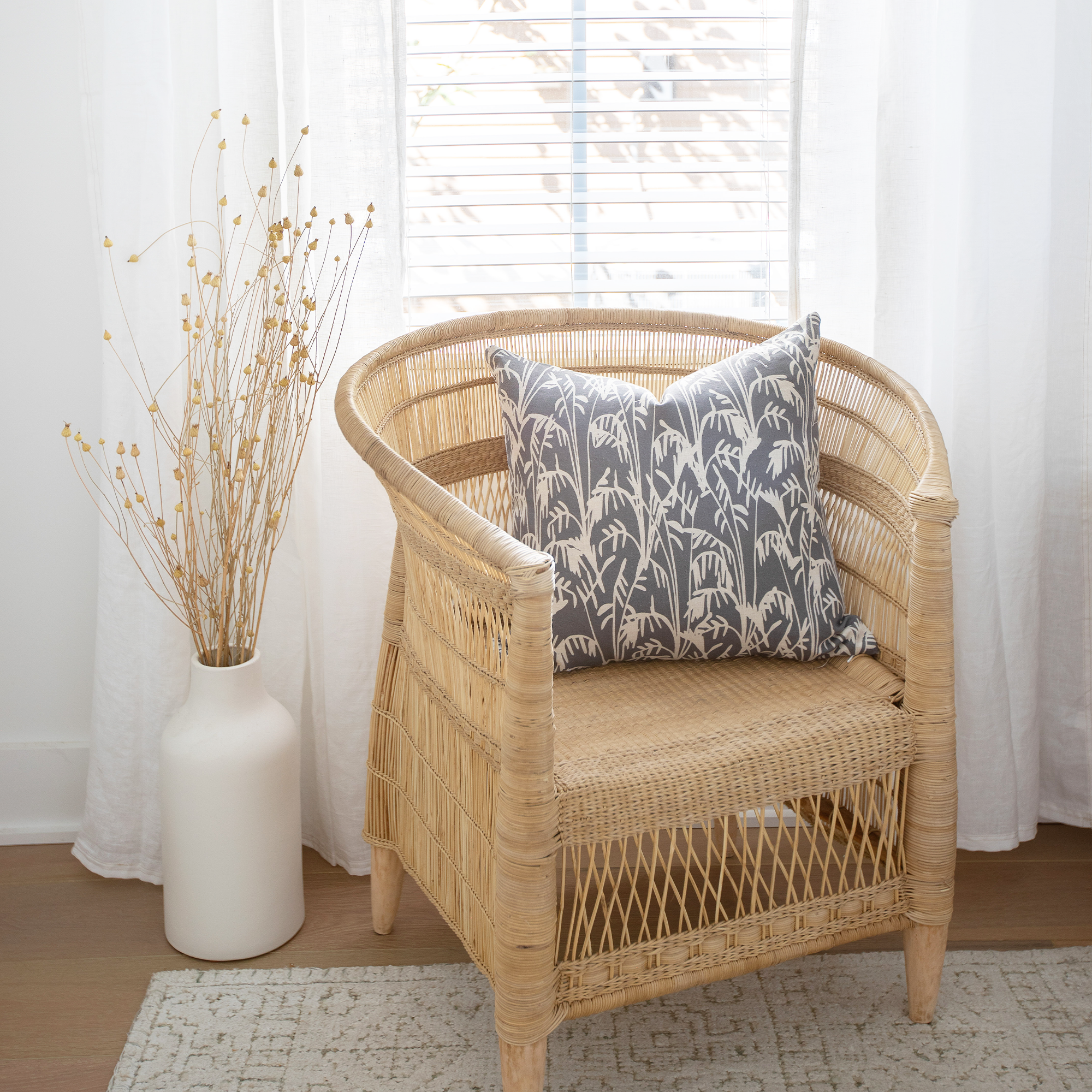 Emily Daws pillows displayed in a Charleston-inspired interior, styled with luxury textiles for artful living spaces