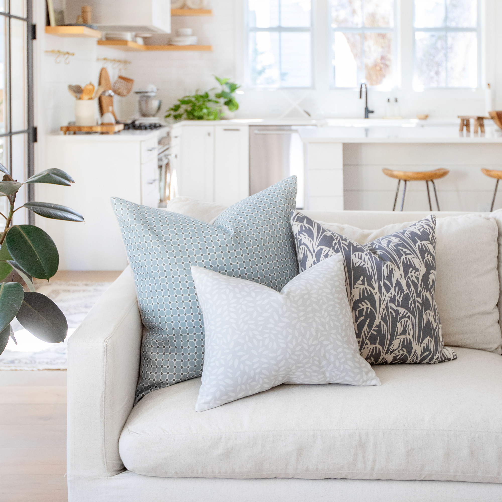 Pair of Emily Daws pillows on a linen sofa, styled for southern-inspired decor and designer homes.