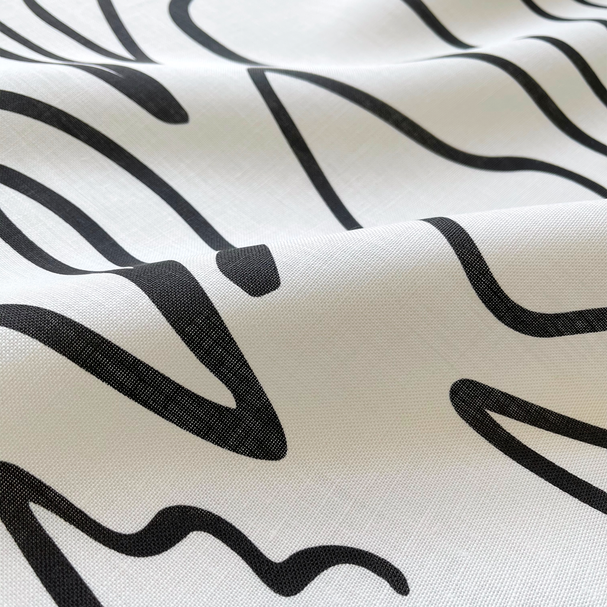 Custom linen fabric by Emily Daws, suitable for window treatments, pillows, and wallcoverings in boutique interiors.