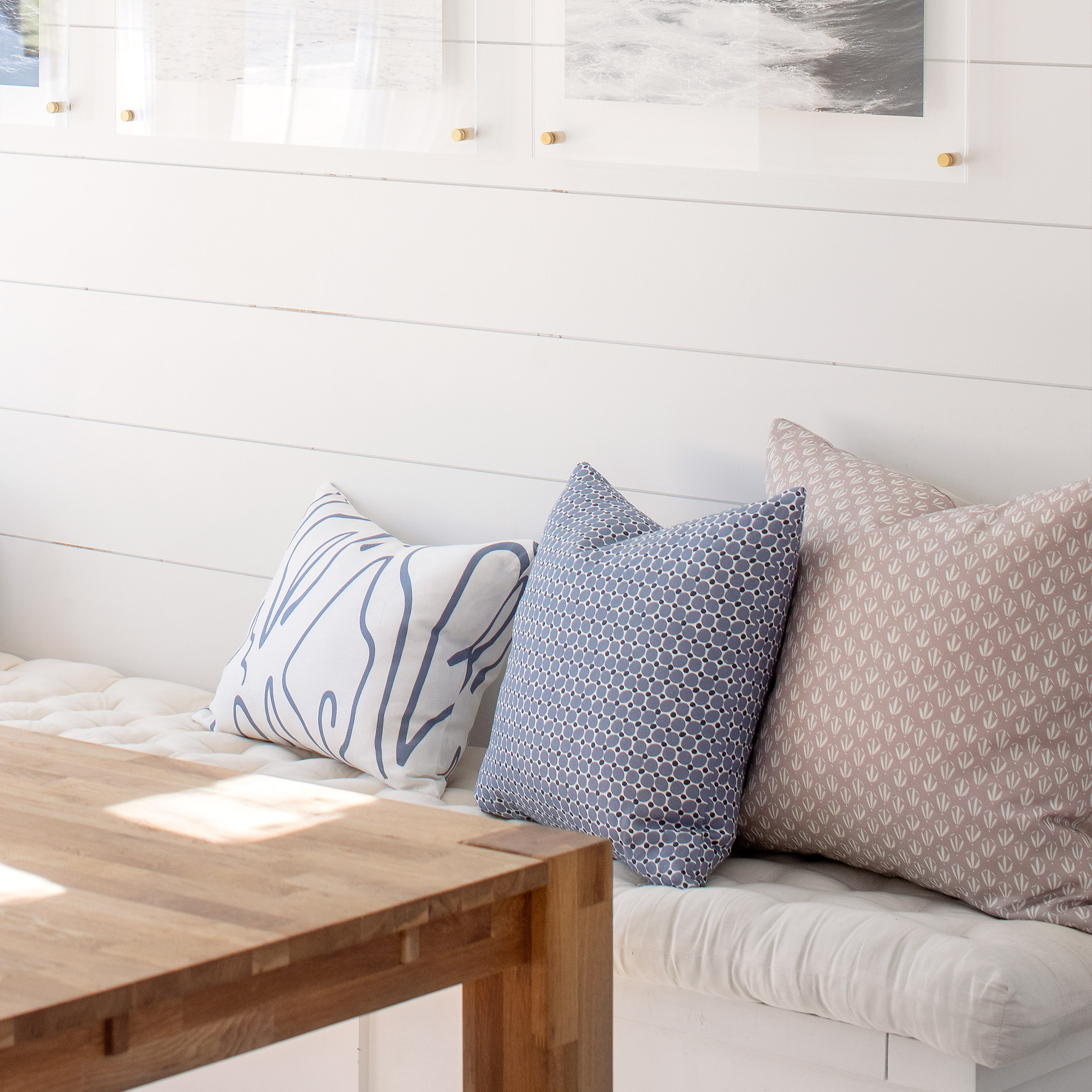 Emily Daws pillows styled in a Charleston-inspired interior, featuring boutique fabrics and southern charm.