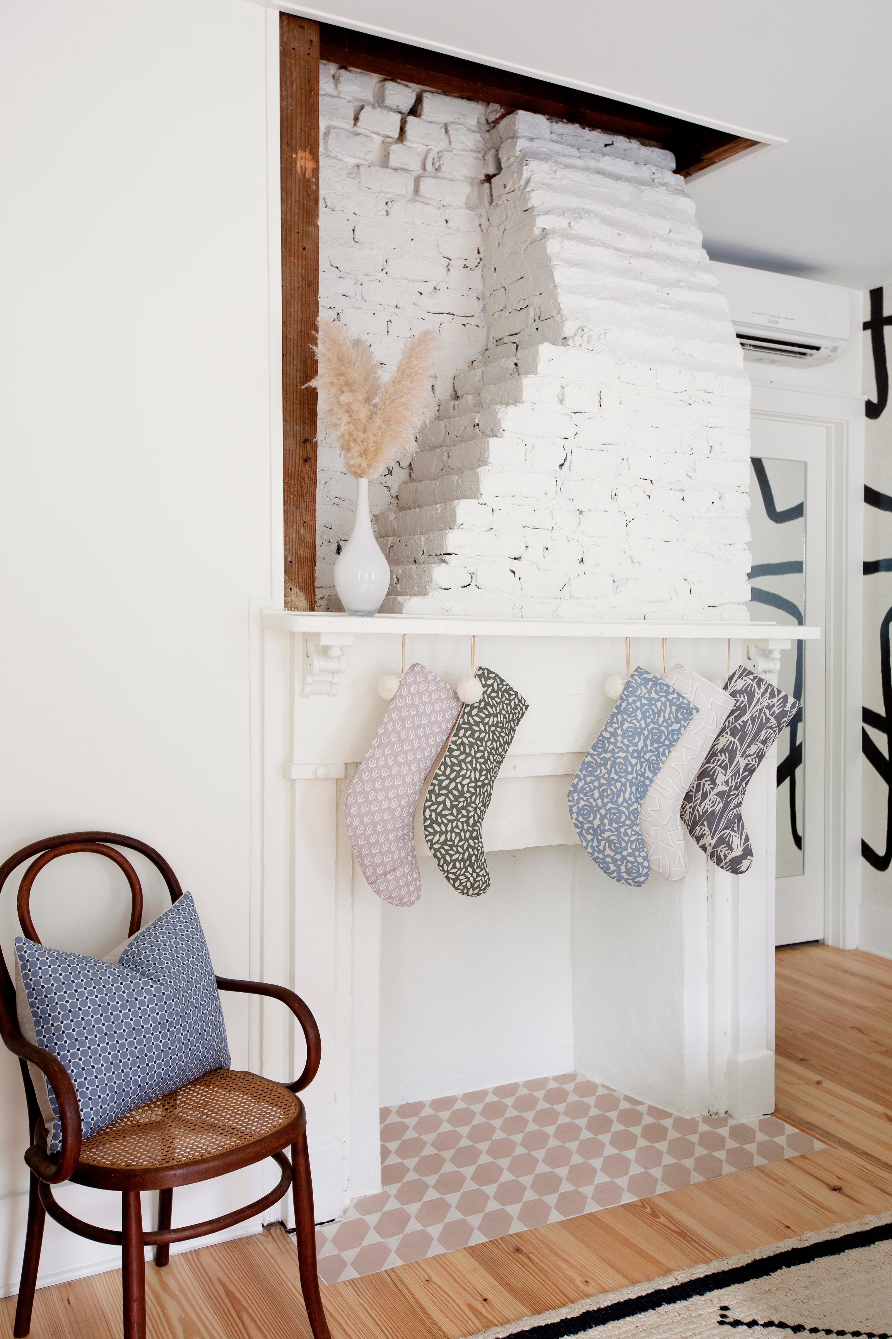 Cobblestone pillow in Ink styled by Emily Daws – featured on a porch or entry bench with natural textures
