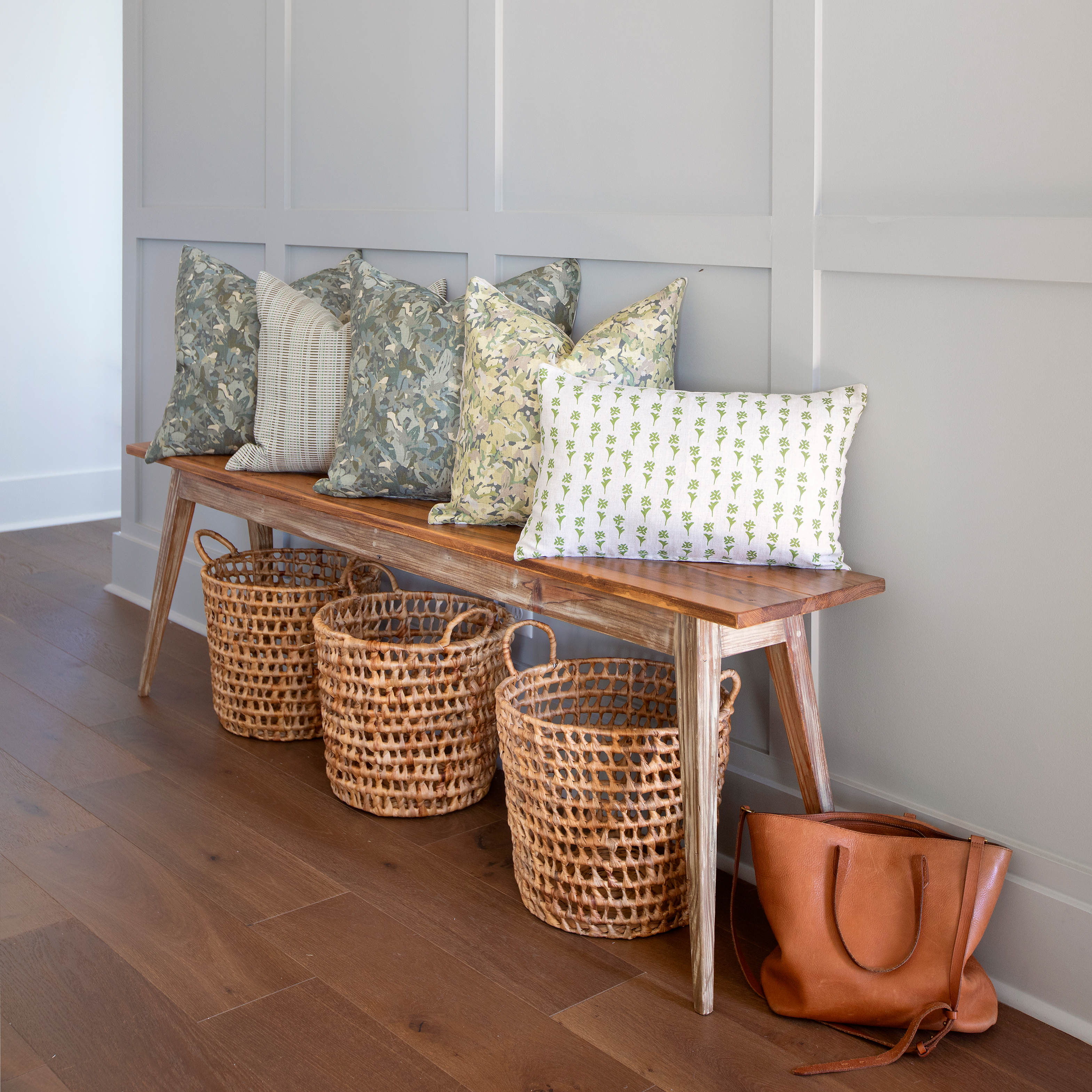 Daffodil pillow in Sprout styled by Emily Daws – placed on a vintage chair with warm wood tones