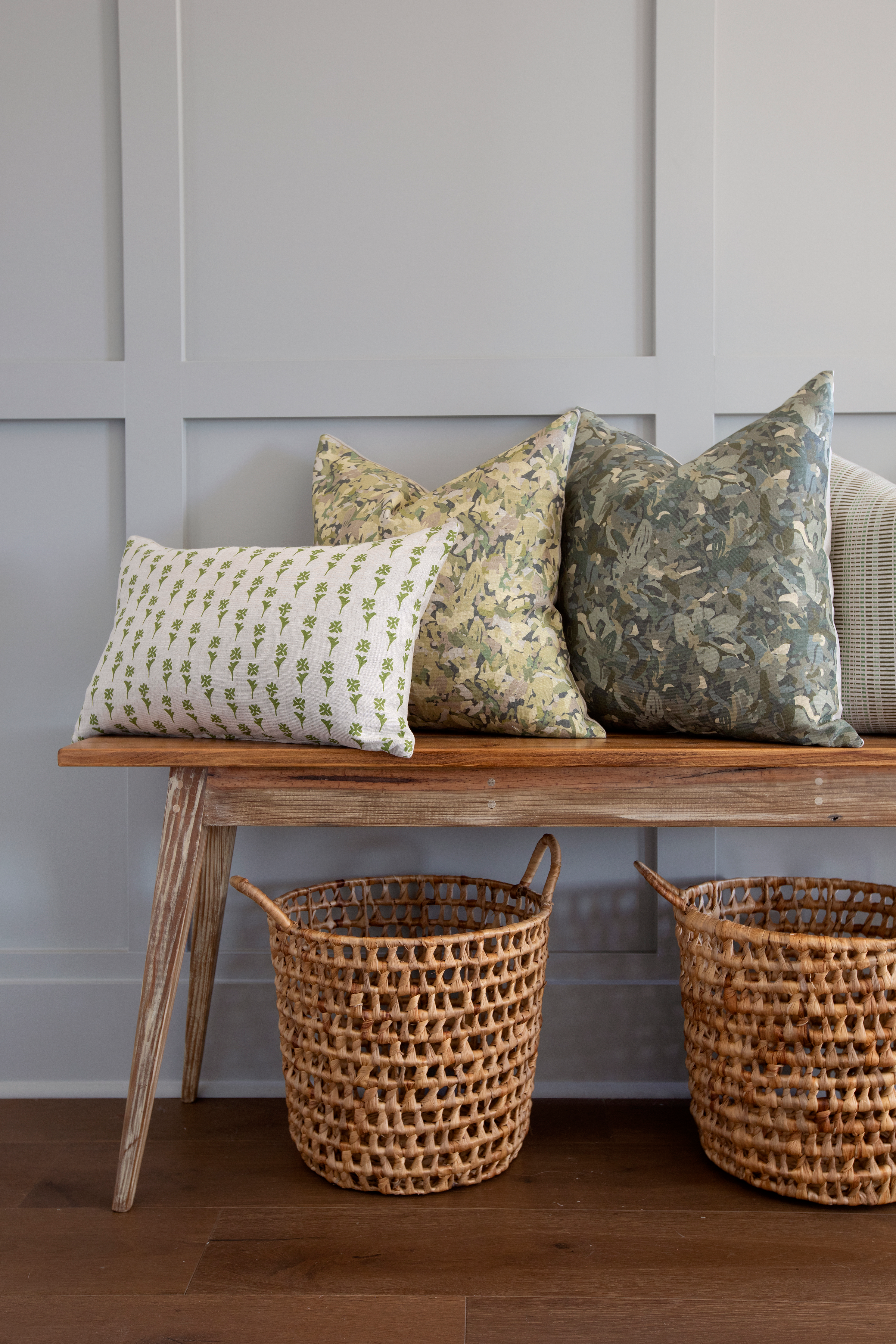 Daffodil pillow in Sprout styled by Emily Daws – layered with quilts in a woodland bedroom setting