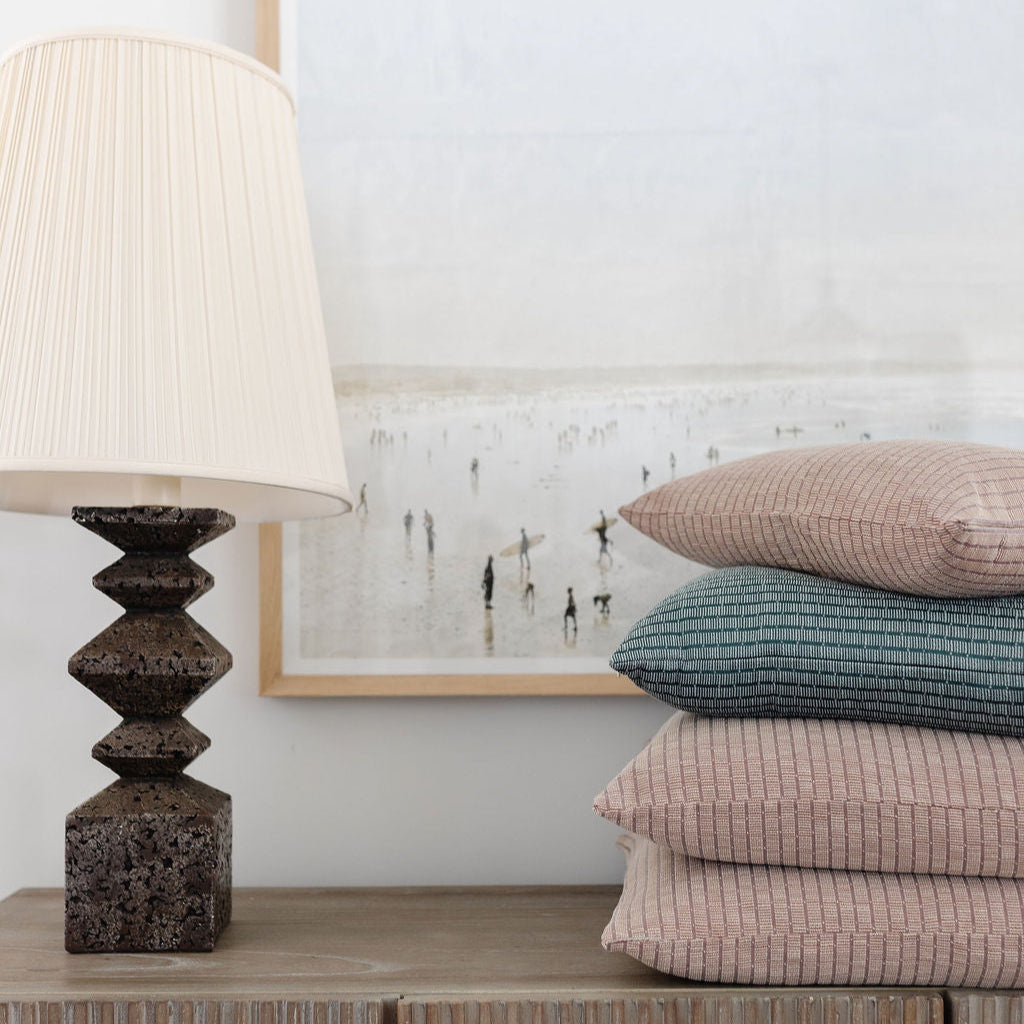 Emily Daws Jetty in Cove woven fabric shown on stack of decorative pillows, designed for refined, storied home settings.