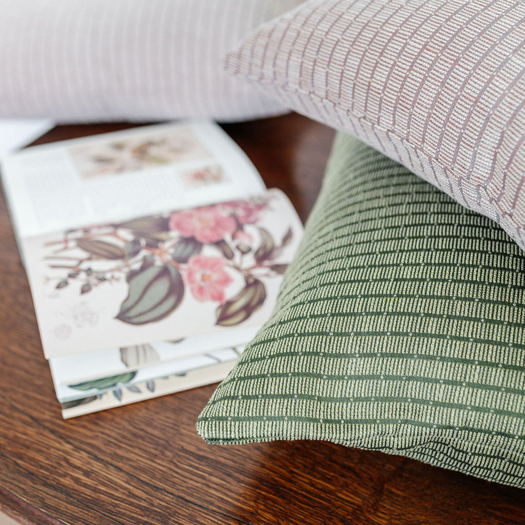 Stacked decorative pillows by Emily Daws, featuring boutique textiles and timeless Southern design.