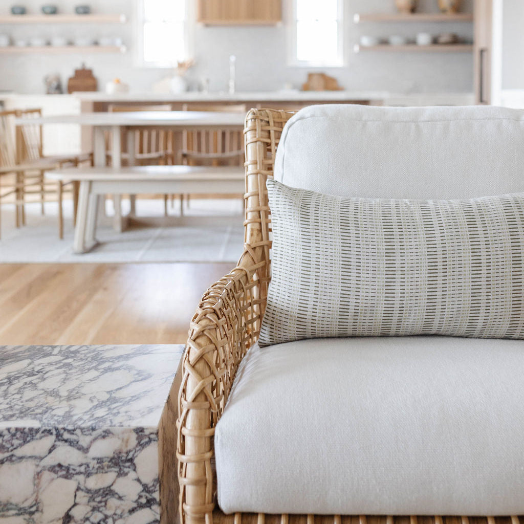 Emily Daws pillows displayed in a Charleston-inspired interior, styled with luxury textiles for artful living spaces.