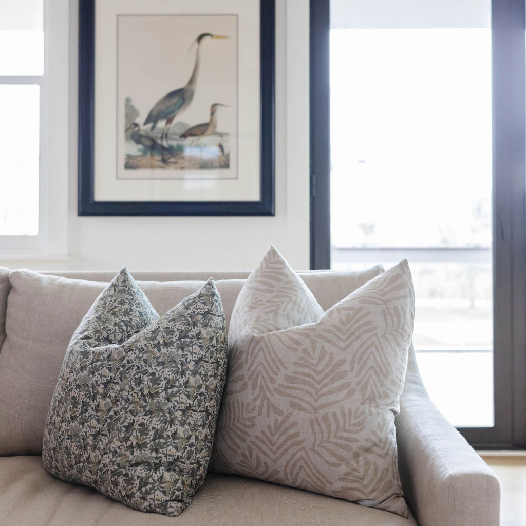 Emily Daws pillows styled in a living room with layered fabrics and patterns, designed for luxury interiors.