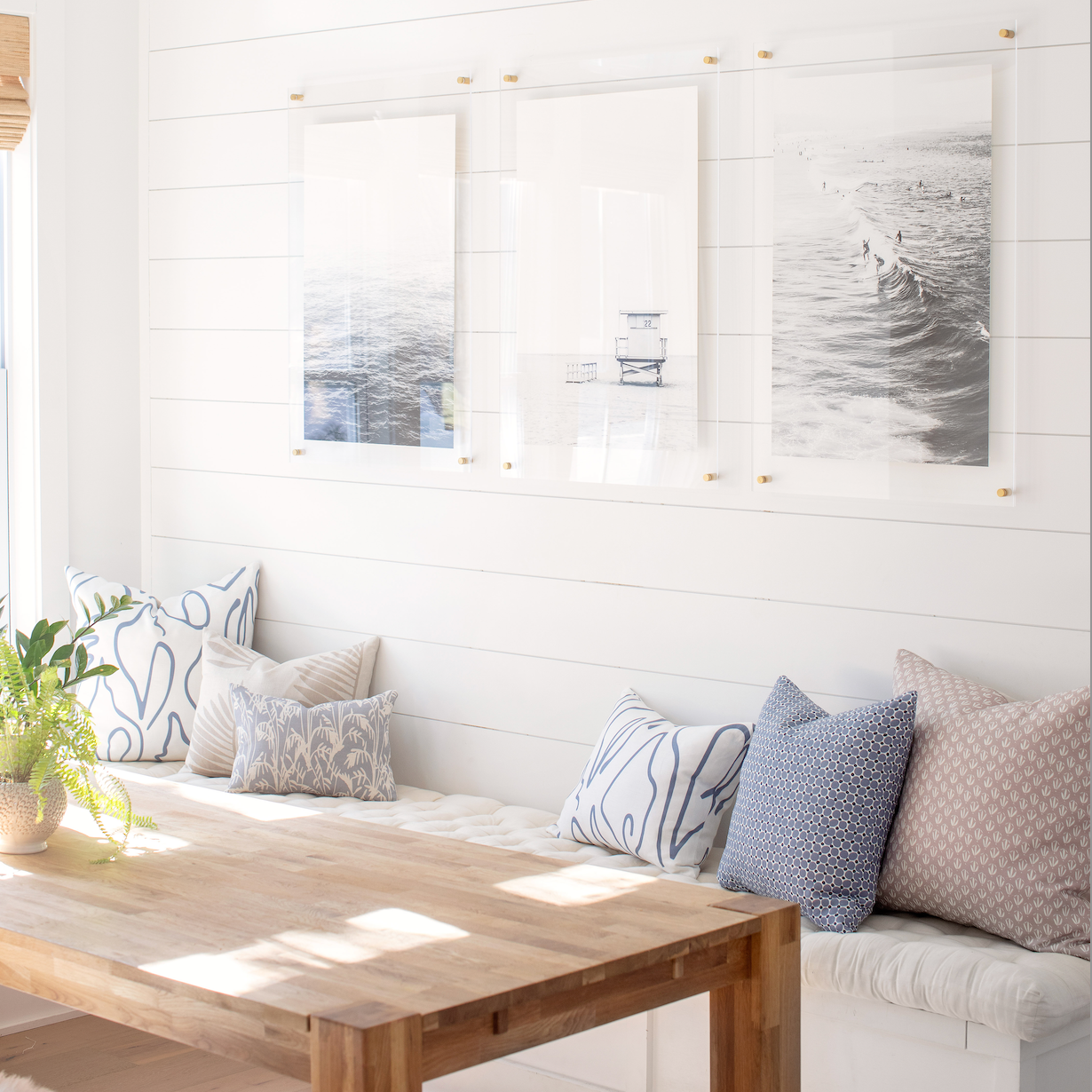 Accent pillows by Emily Daws styled on a window seat, designed for cozy spaces and bespoke interiors.