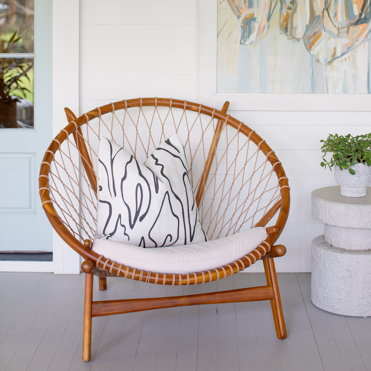 Armchair styled with Emily Daws pillows, featuring handcrafted details and linen fabrics for classic interiors.