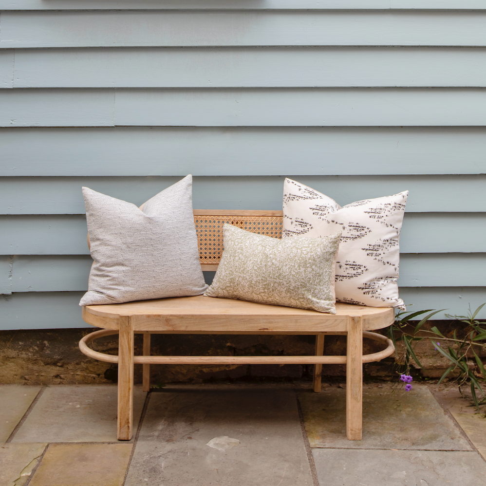 Bench seating styled with Emily Daws pillows in Belgian linen fabrics, created for trade professionals and clients.