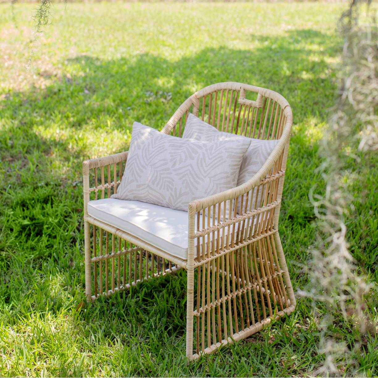 Armchair styled with Emily Daws pillows, featuring handcrafted details and linen fabrics for classic interiors.