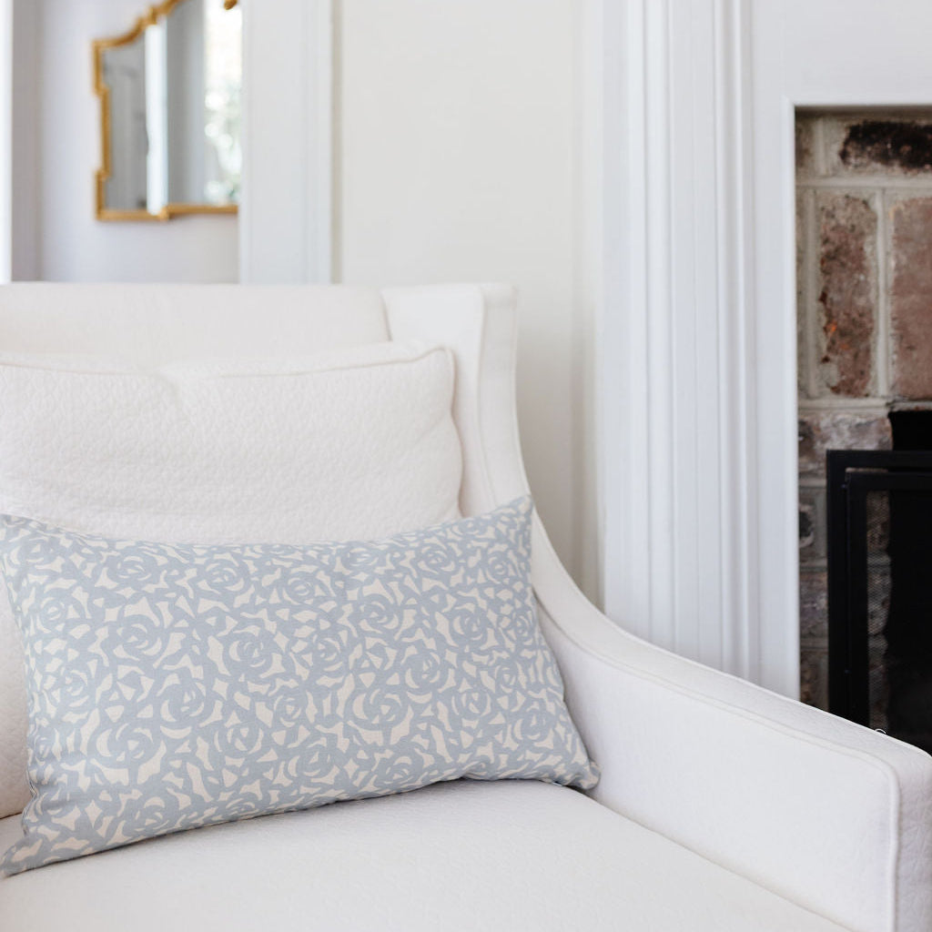 Armchair styled with Emily Daws pillows, featuring handcrafted details and linen fabrics for classic interiors.