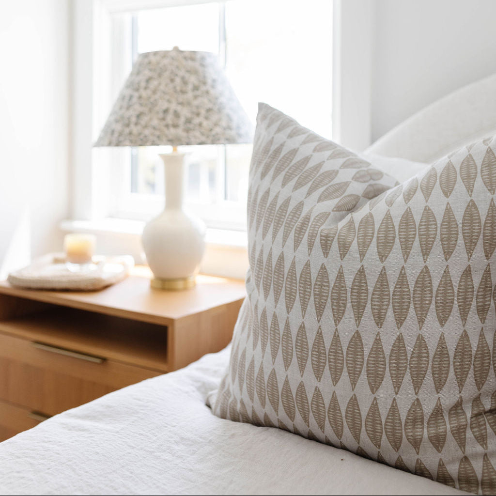 Emily Daws pillows displayed in a Charleston-inspired interior, styled with luxury textiles for artful living spaces.