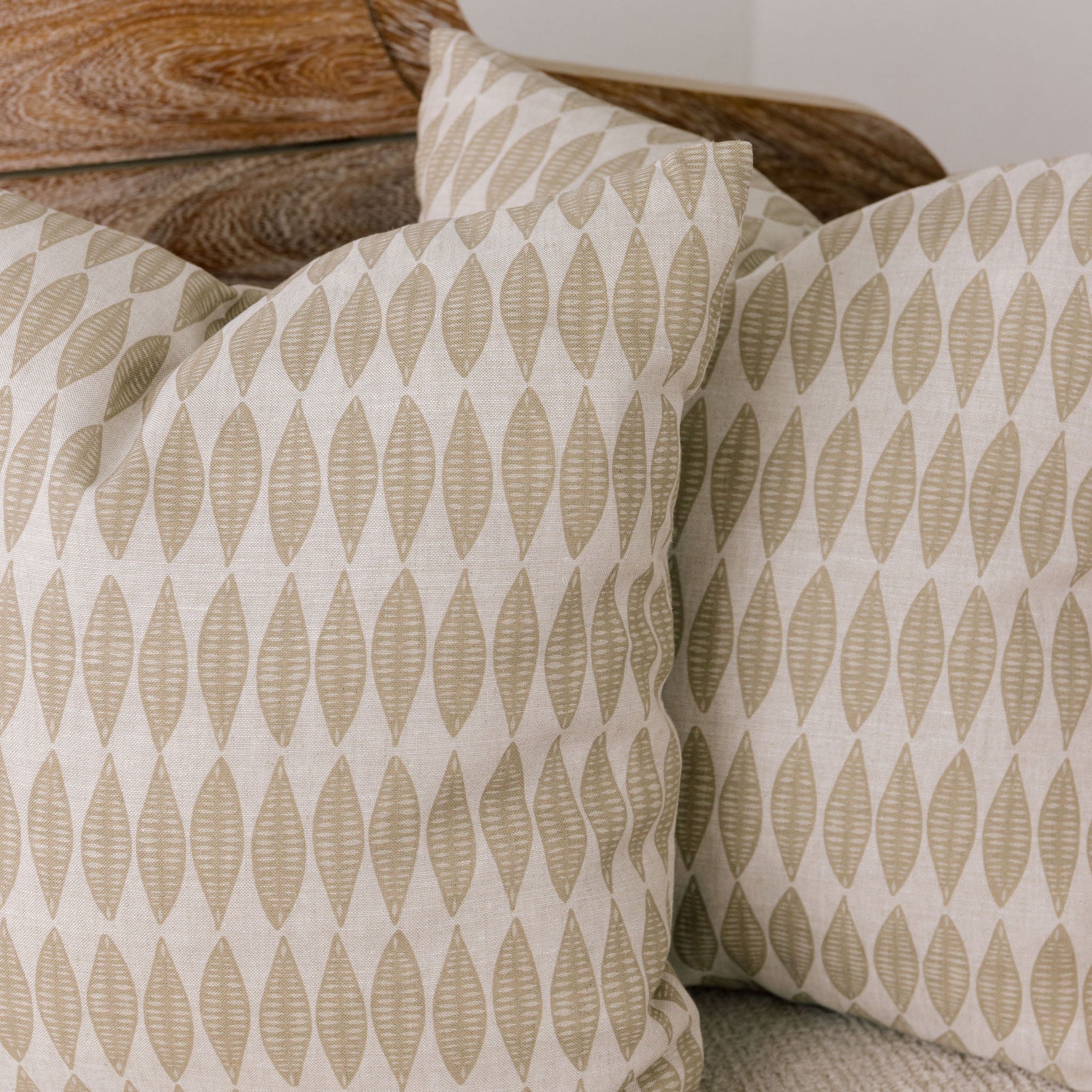Emily Daws pillows styled in a coastal cottage living room, designed with small-batch fabrics for interior designers.