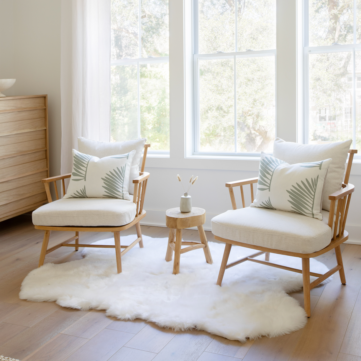 Pair of Emily Daws pillows on a chair, crafted in linen fabrics and styled for classic, artful Southern interiors.