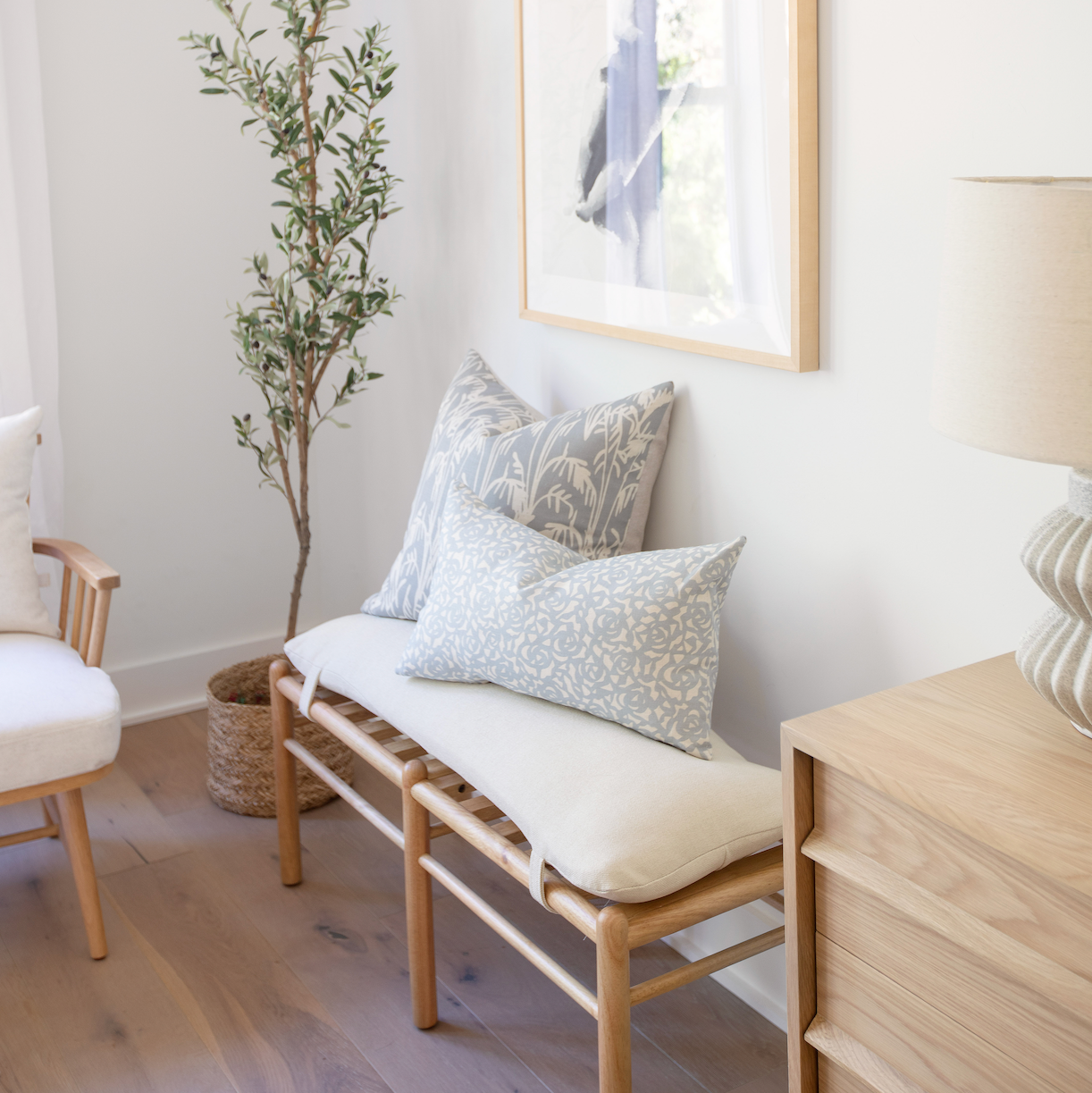 Accent pillows by Emily Daws styled on a window seat, designed for cozy spaces and bespoke interiors.