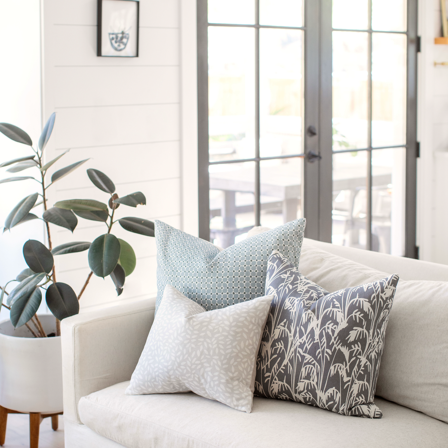 Emily Daws pillows styled in a living room with layered fabrics and patterns, designed for luxury interiors.