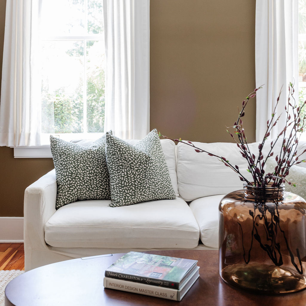 Styled sofa with Emily Daws pillows in small-batch fabrics, designed for interior designers and bespoke interiors.