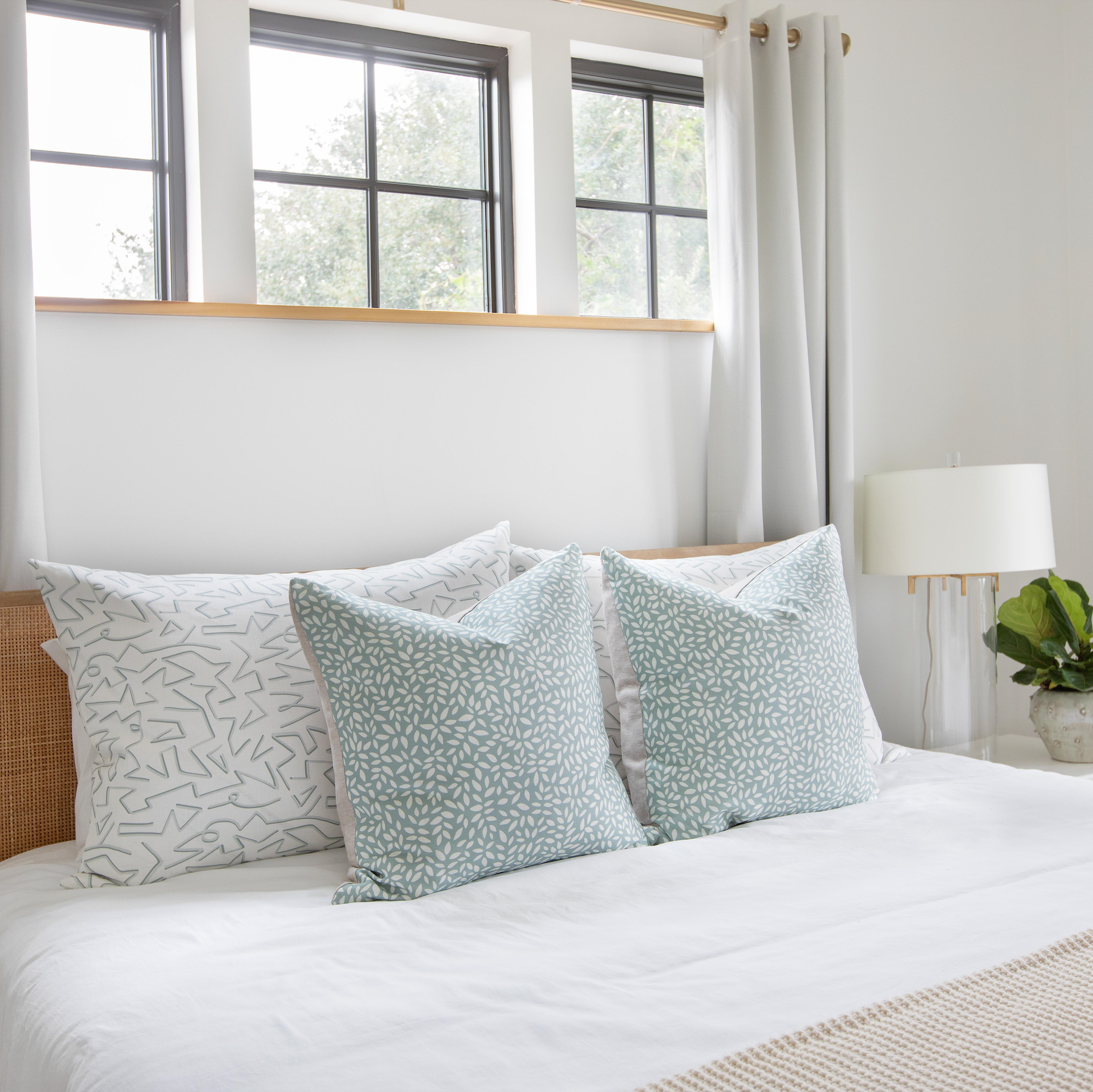 Emily Daws pillows styled in layered tones and textures, crafted for Southern-inspired interiors and cozy spaces.