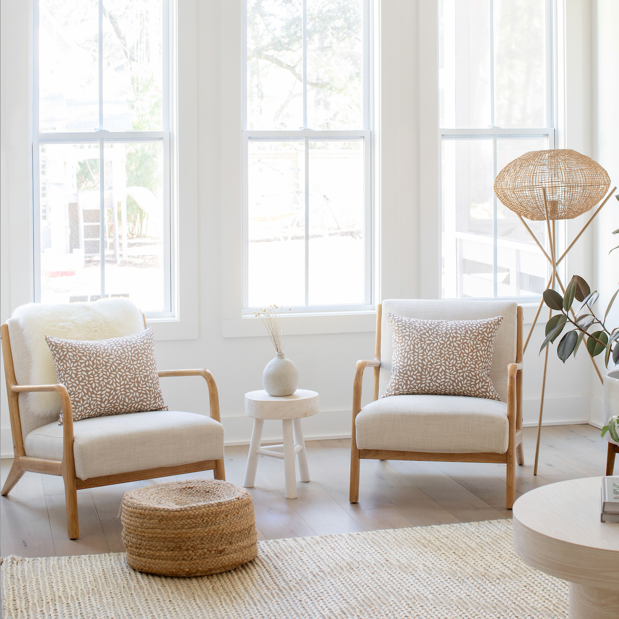Pair of Emily Daws pillows on a chair, crafted in linen fabrics and styled for classic, artful Southern interiors.