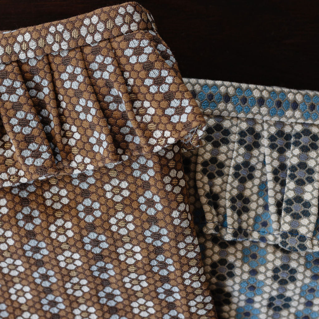 Close-up of Nectar fabric by Emily Daws with brown, blue, and beige colors.