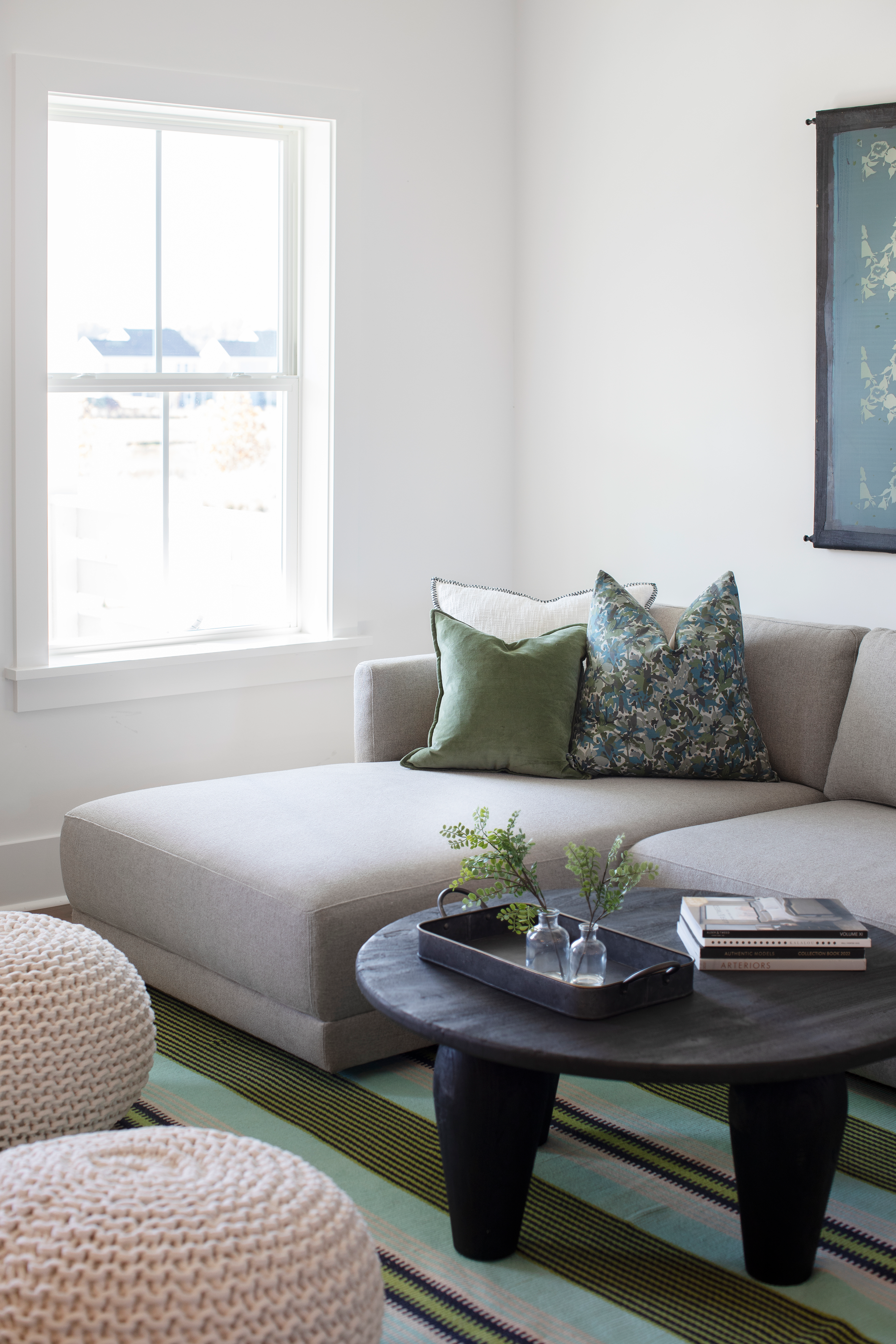 Thicket pillow in Emerald styled by Emily Daws – layered with quilts in a woodland bedroom setting
