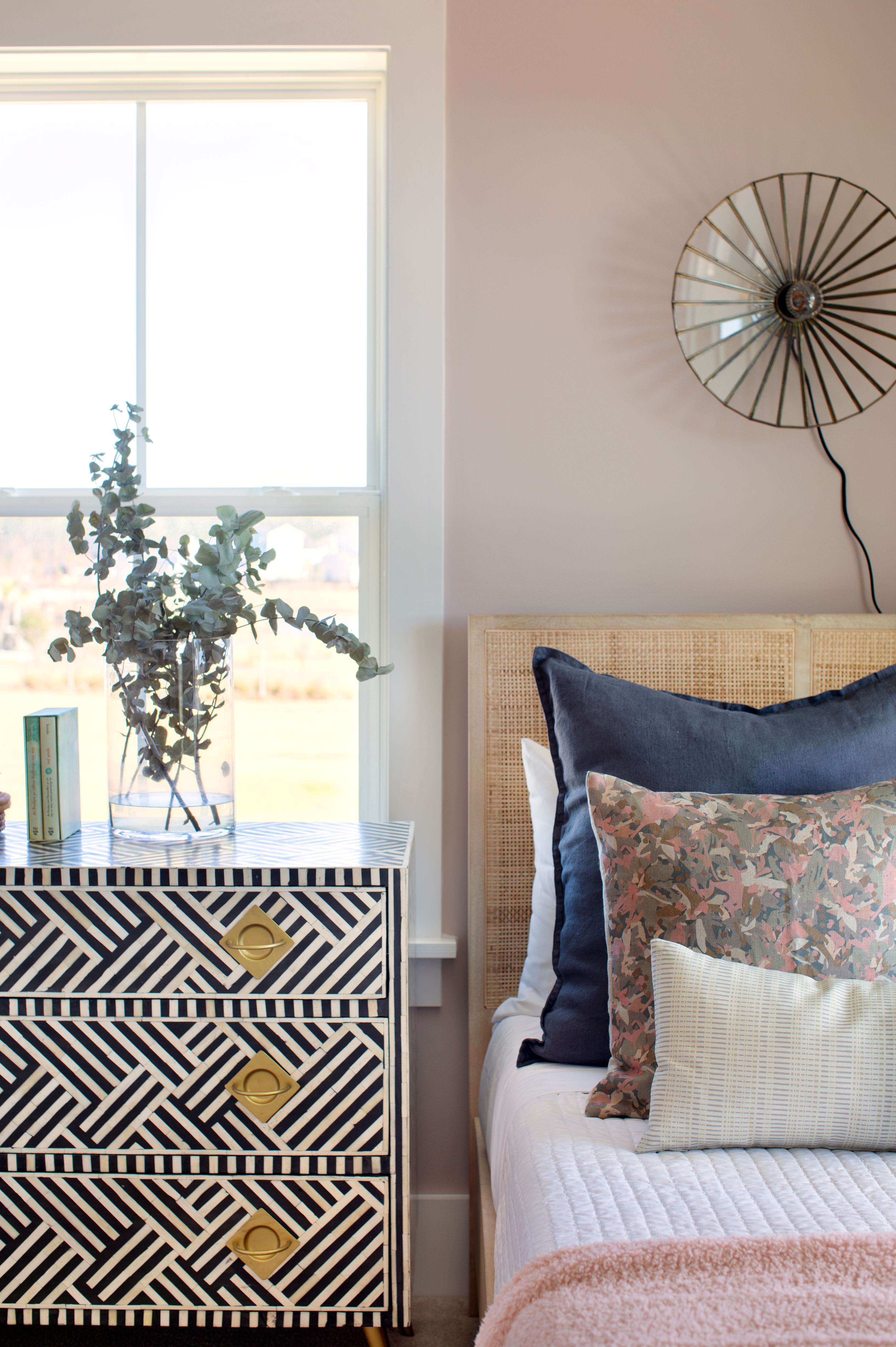Thicket pillow in Rouge styled by Emily Daws – placed on a vintage chair with warm wood tones