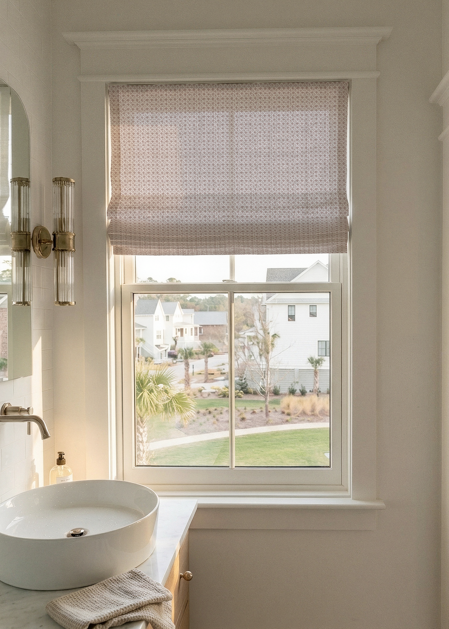 Bathroom with a window view of a residential area with Roman shade by Emily Daws in Carolina Rice Linen fabric by the yard.