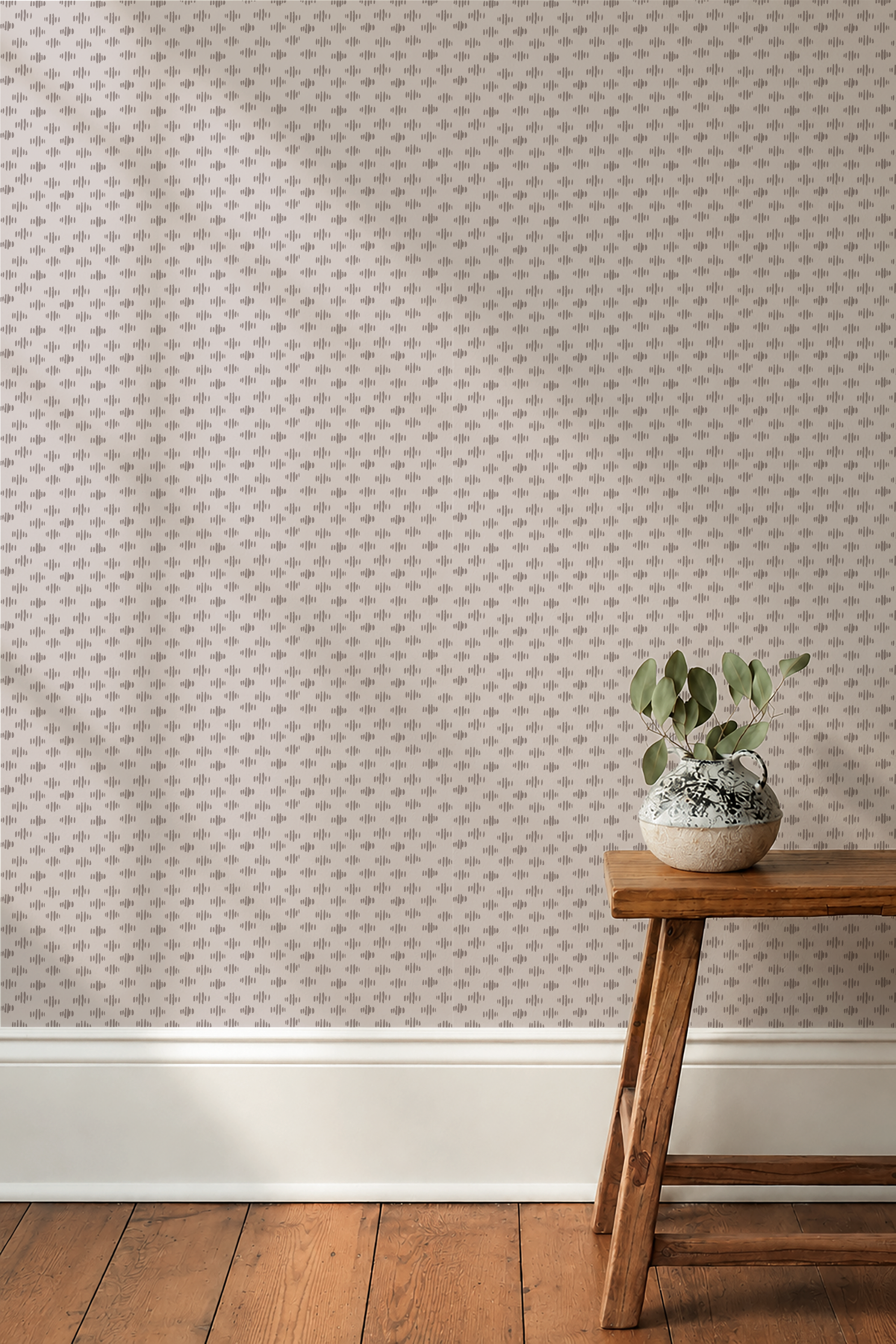 Emily Daws Pip Stitch Wallpaper in Primrose, a light pink neutral color wallpaper with a stool and small plant