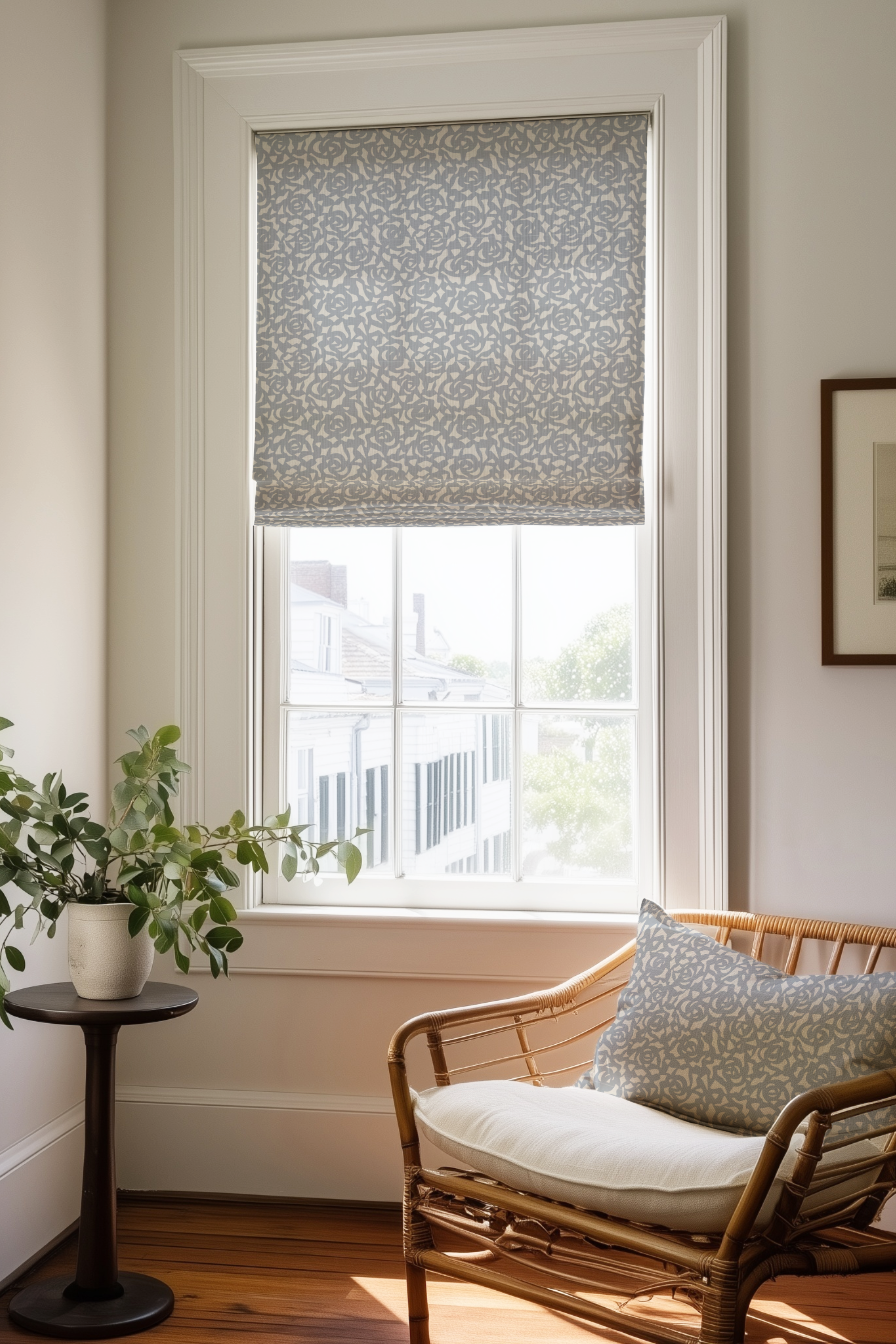 Corner of a bedroom in a Charleston home with a Roman shade and pillow in Gardenia fabric in Marina by Emily Daws.