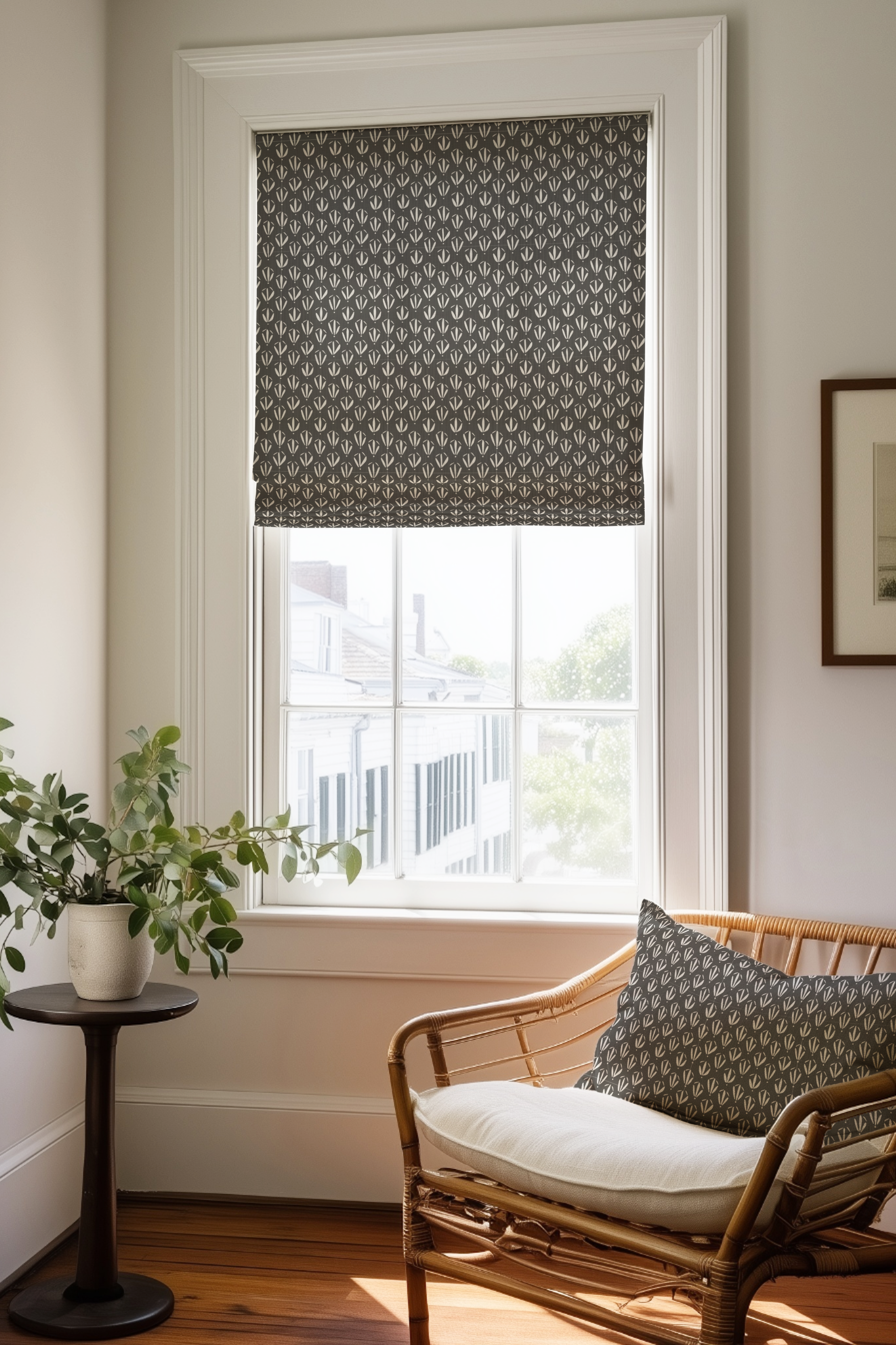 Corner of a bedroom in a Charleston home with a Roman shade and pillow in Kiawah fabric in Coal by Emily Daws.
